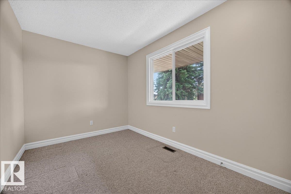 Neutral-toned walls complement the carpeted flooring - #47 3812 20 Av Nw, Edmonton, AB