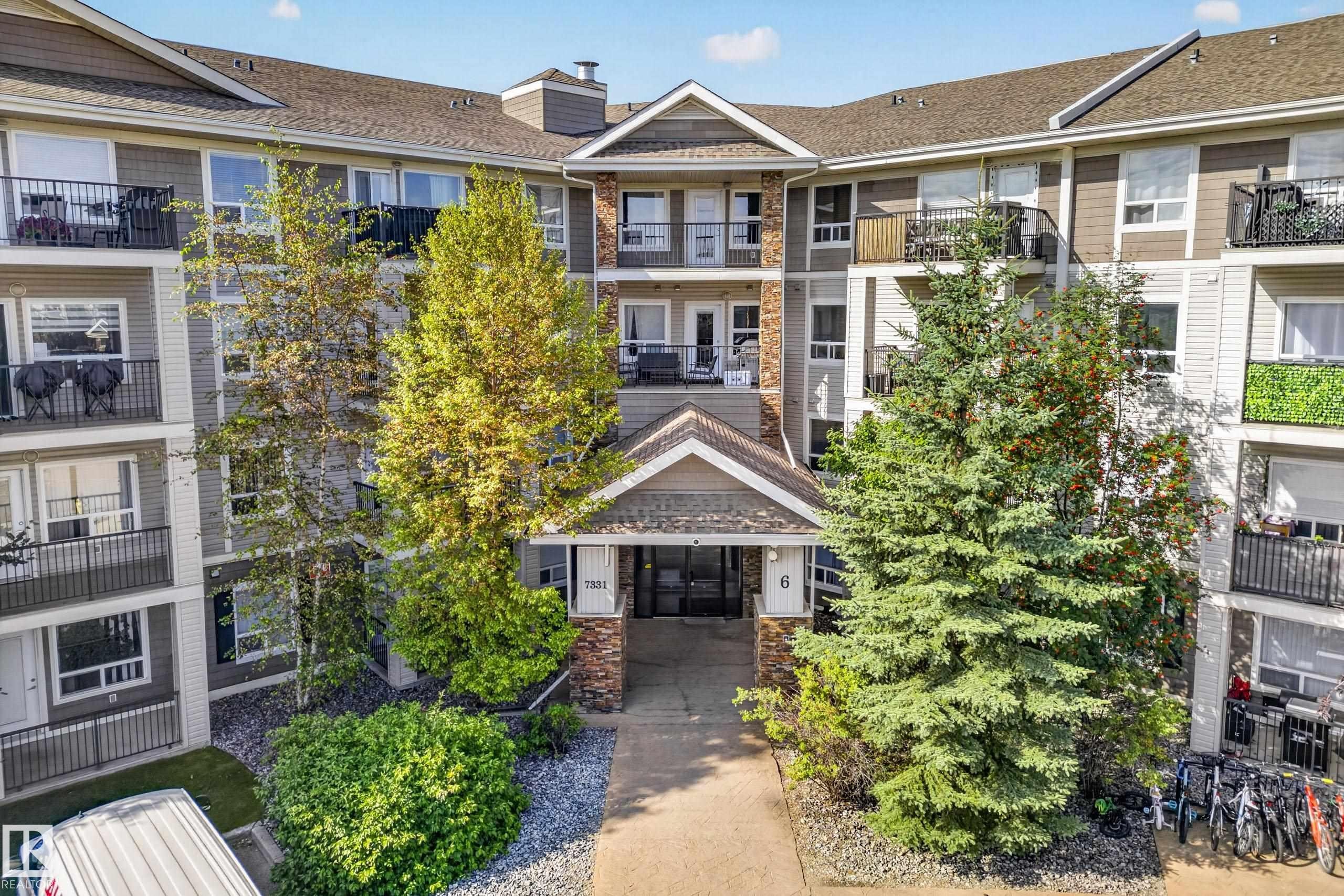 Multi-story residential building with private balconies and a gabled main entrance - #6430 7331 South Terwillegar Dr Nw, Edmonton, AB