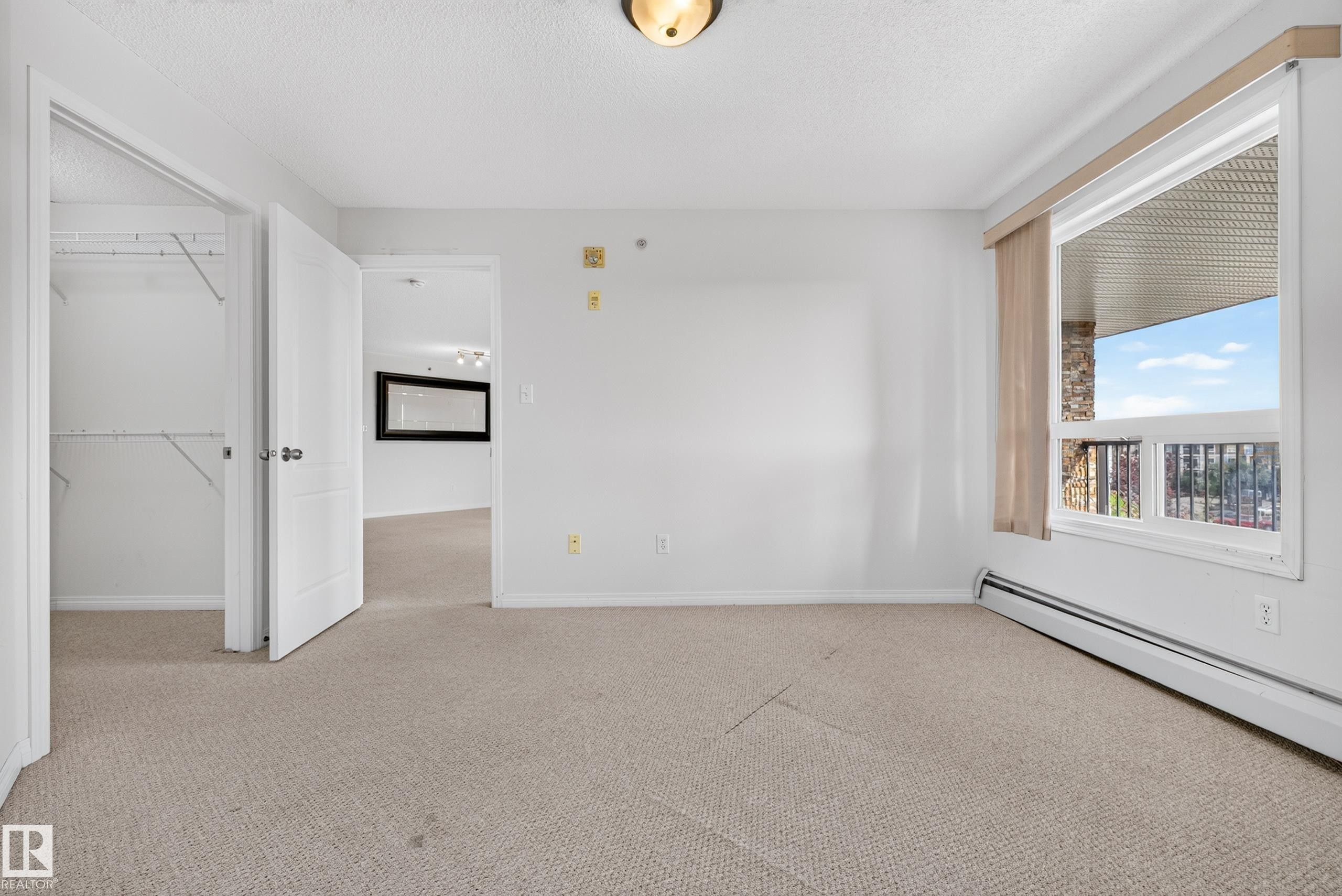 Carpeted flooring, white walls, and a built-in closet with shelving - #6430 7331 South Terwillegar Dr Nw, Edmonton, AB