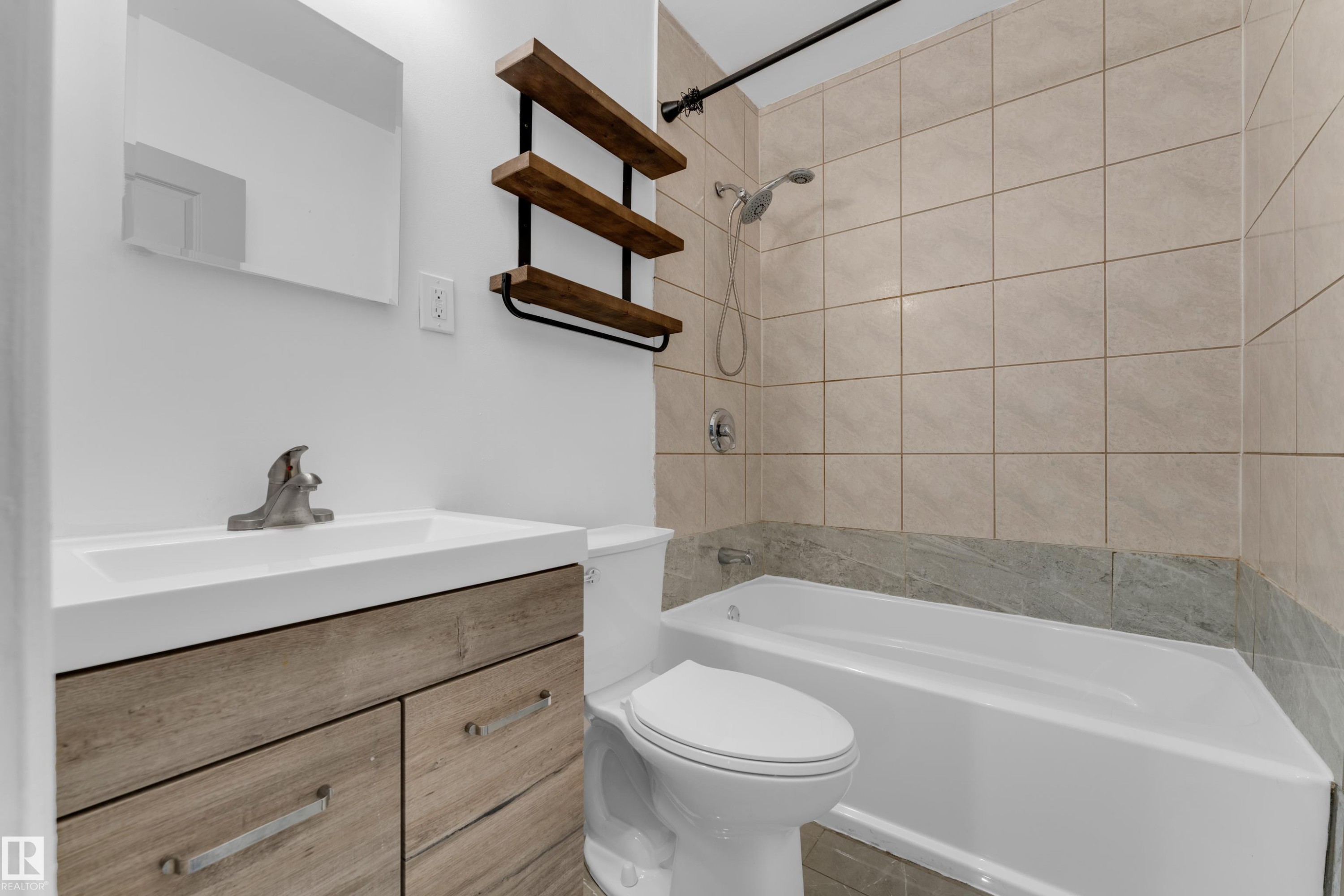 Vanity with wood-finish cabinetry, integrated sink, and brushed nickel faucet - 12116 81 Street Nw, Edmonton, AB