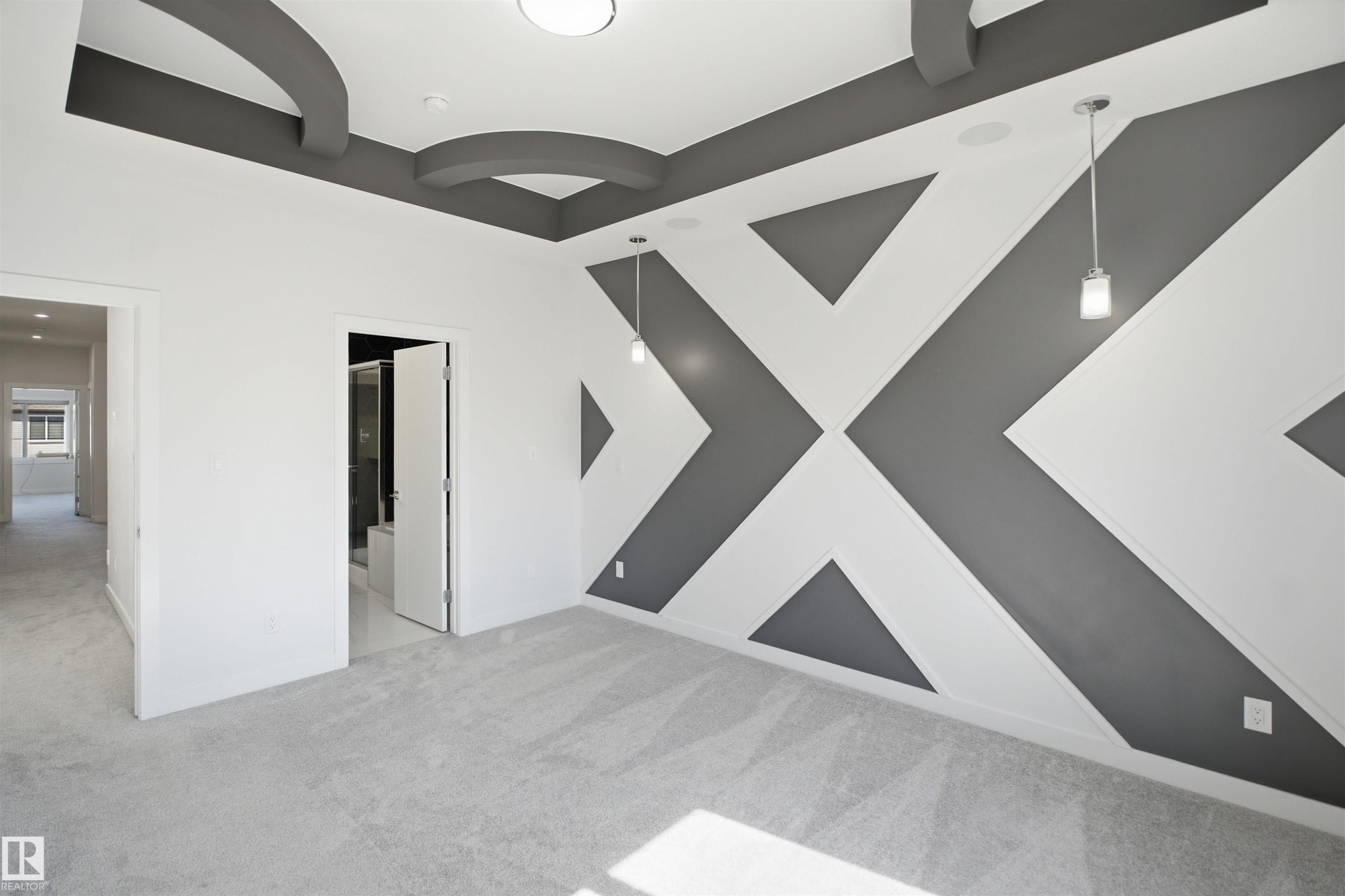 Geometric accent wall with recessed lighting and pendant fixtures - 2027 13 Avenue Nw, Edmonton, AB
