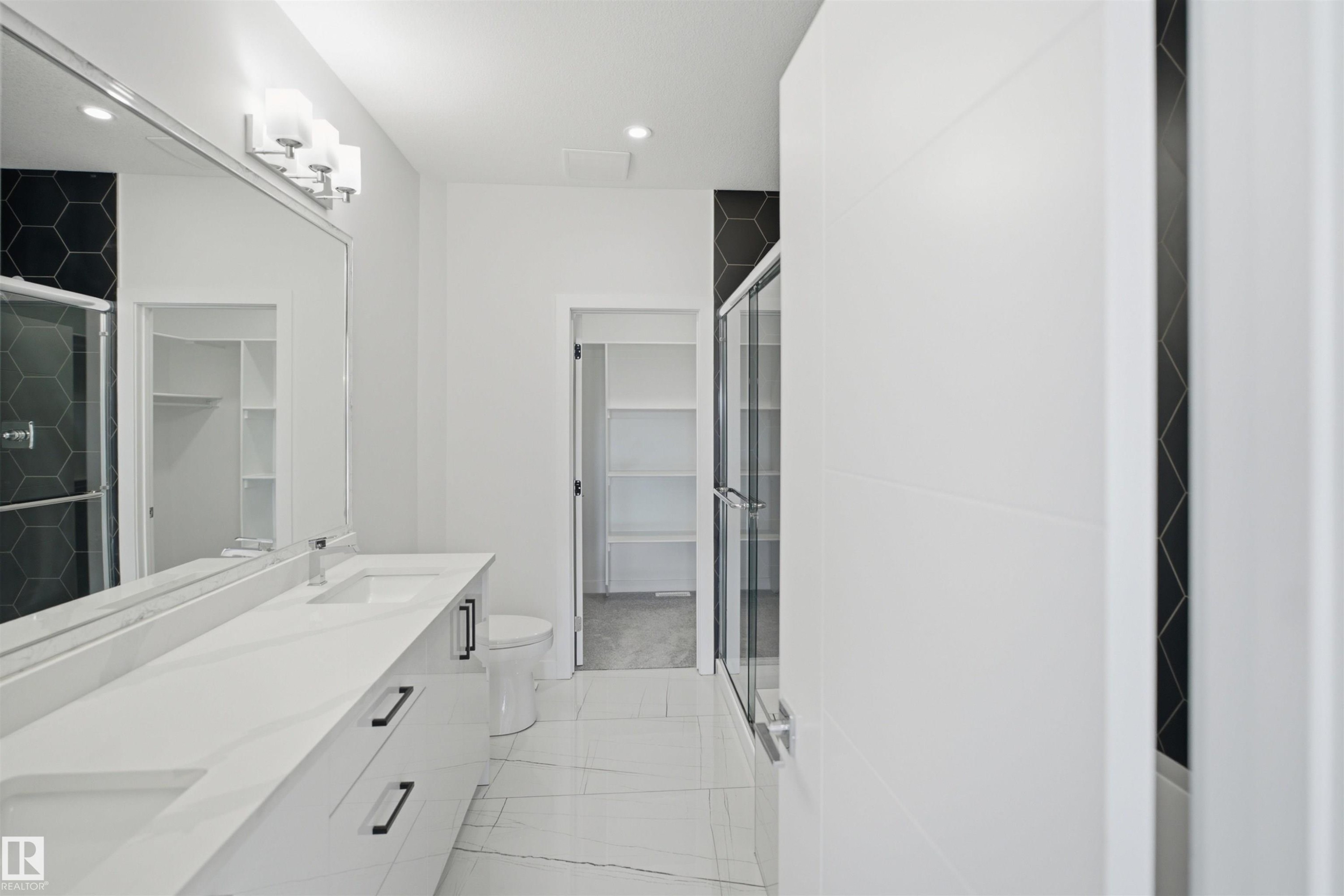 Double vanity with integrated sinks and black cabinet hardware - 2027 13 Avenue Nw, Edmonton, AB