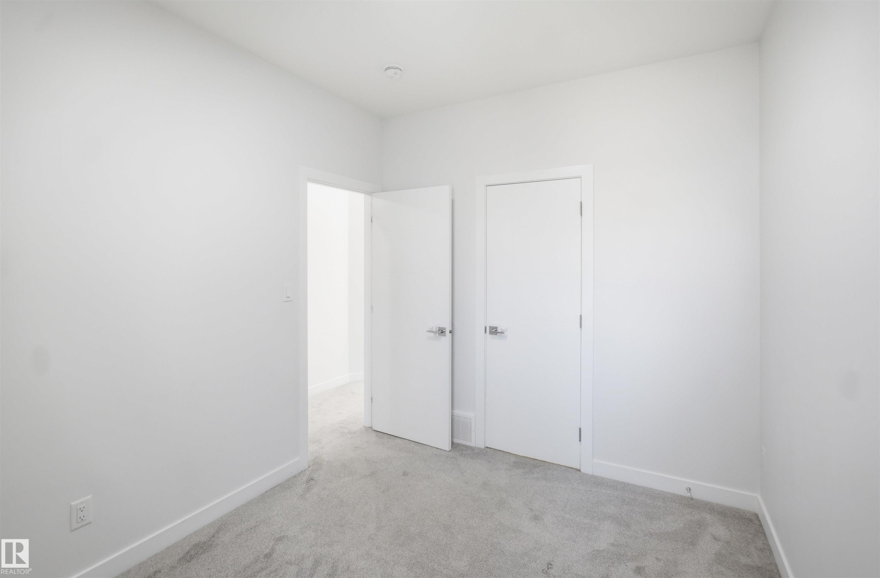 Light gray carpet flooring and white painted walls - 2027 13 Avenue Nw, Edmonton, AB