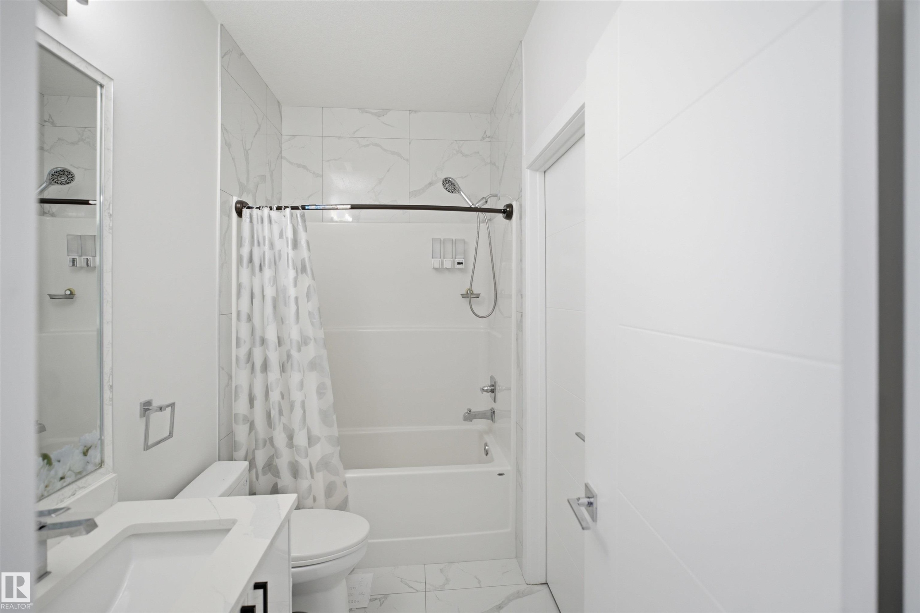 White vanity with integrated sink, chrome faucet, and mirrored medicine cabinet - 2027 13 Avenue Nw, Edmonton, AB