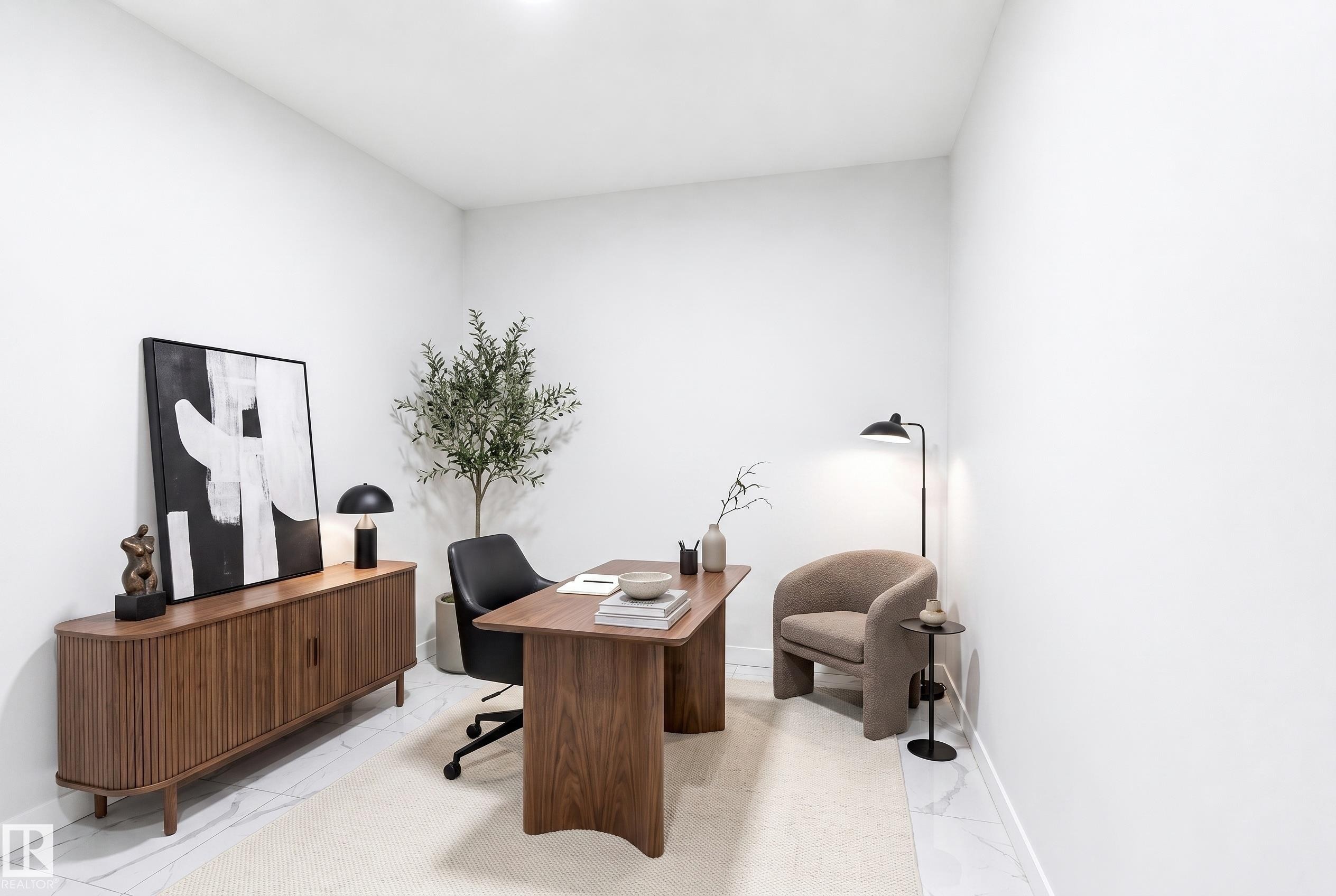 Bright interior room with white walls and a light-colored floor, featuring a built-in overhead light fixture - 2027 13 Avenue Nw, Edmonton, AB