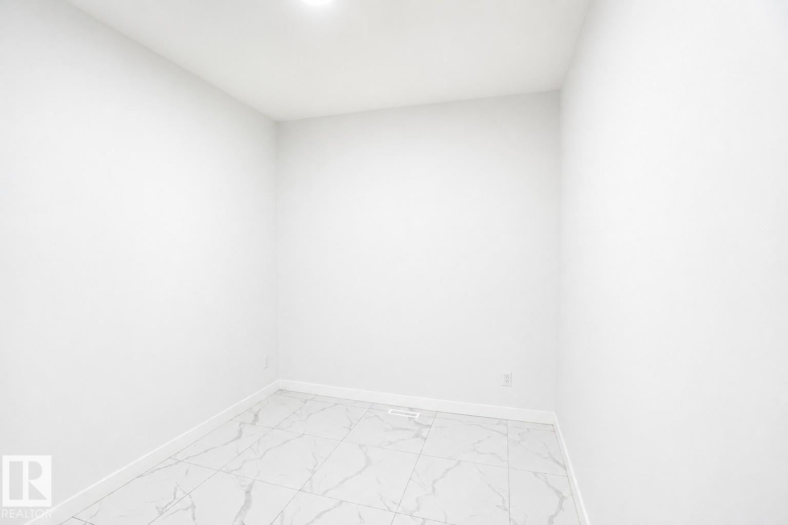Recessed lighting, light-toned walls, and large format tile flooring - 2027 13 Avenue Nw, Edmonton, AB