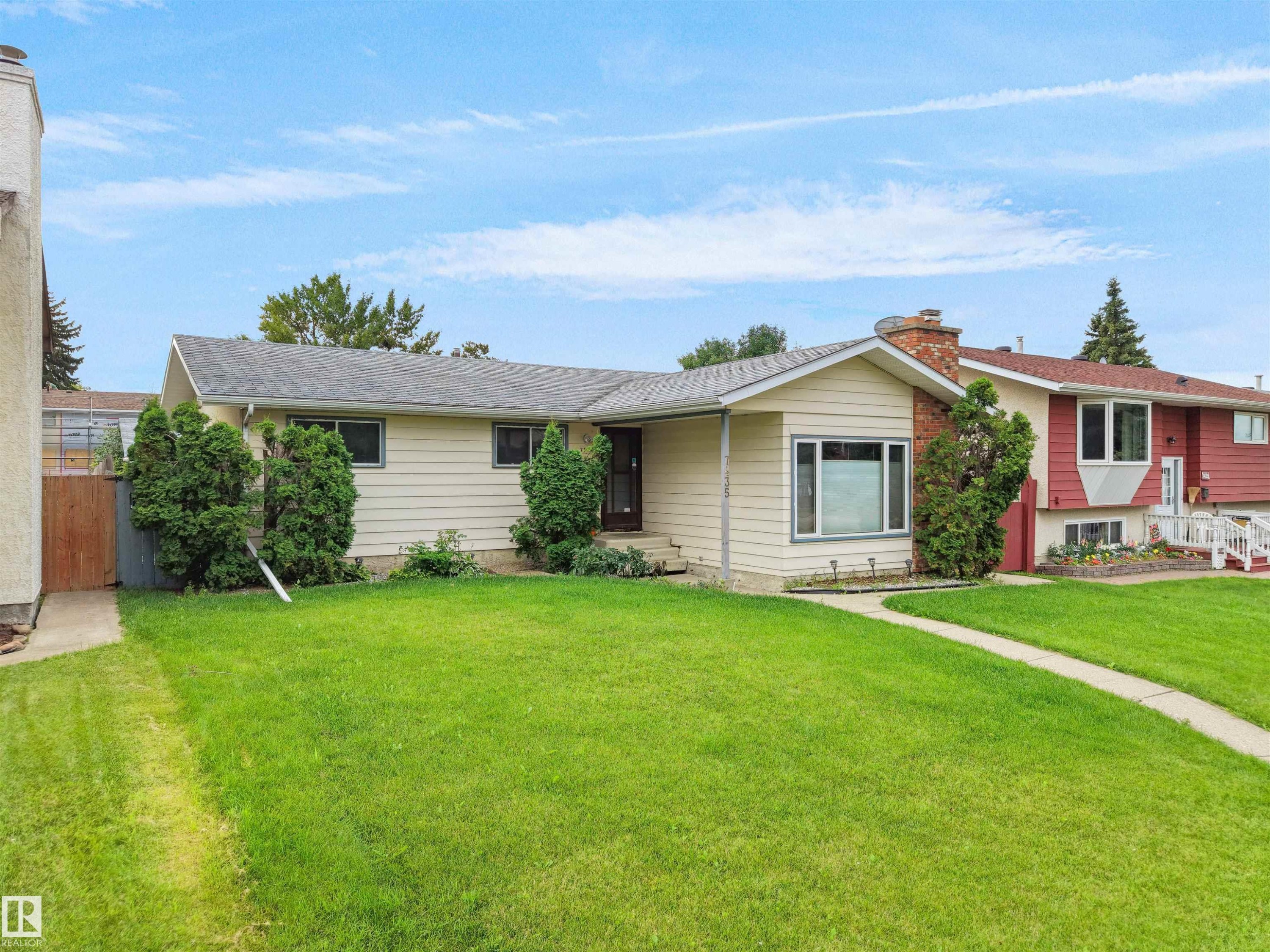 Cream-colored siding exterior with a dark roof - 7435 32 Avenue Nw, Edmonton, AB