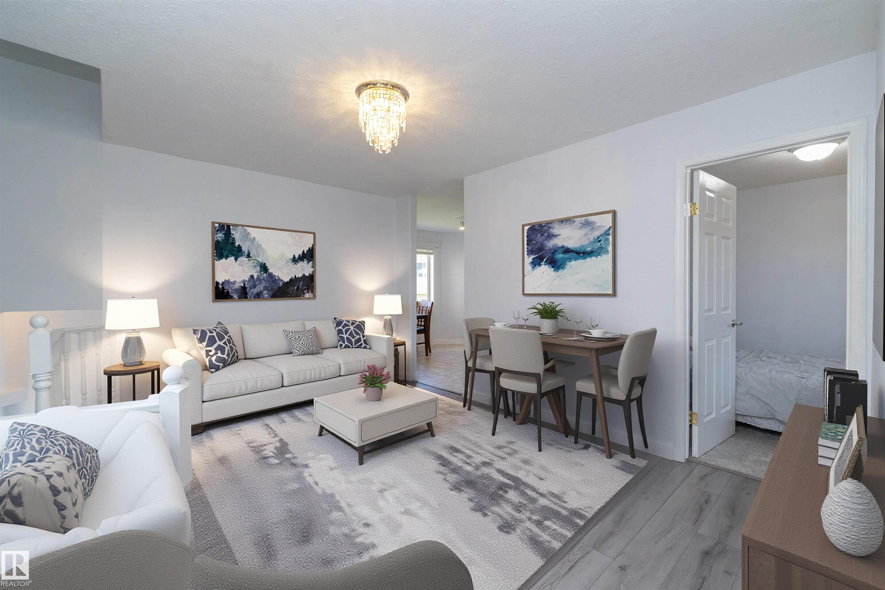 Open-concept living area with wood-finish flooring, a crystal chandelier, and a dining space - #37 3811 85 St Nw, Edmonton, AB