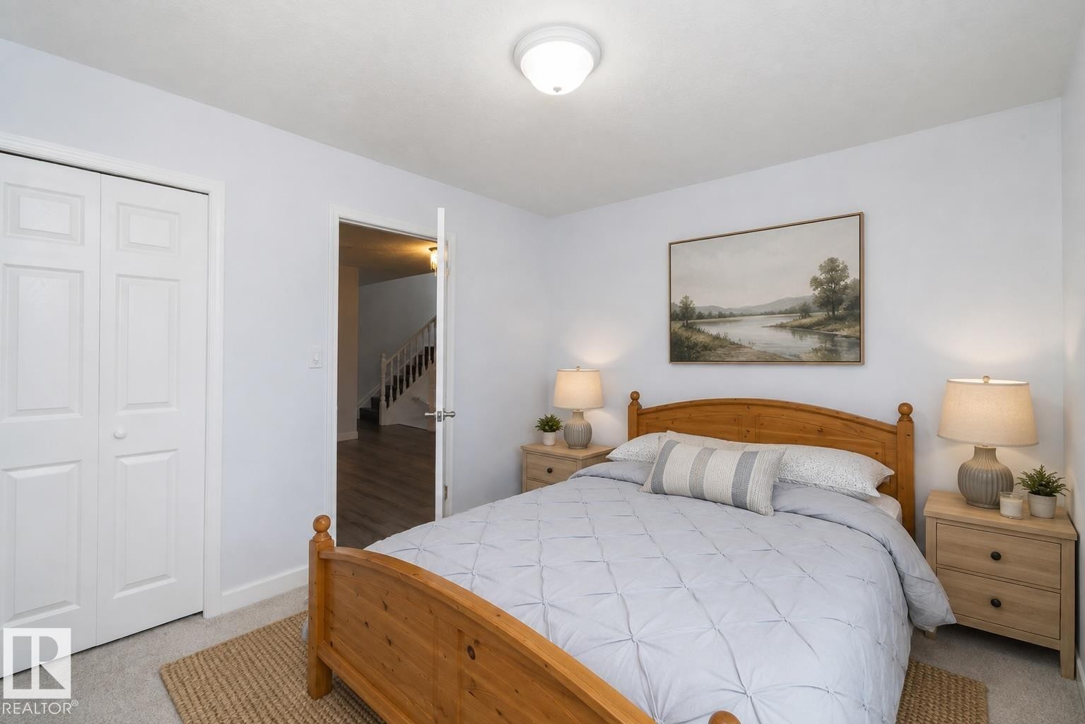 Ceiling-mounted light fixture, white bi-fold closet doors, light-toned walls, and grey carpet flooring - #37 3811 85 St Nw, Edmonton, AB