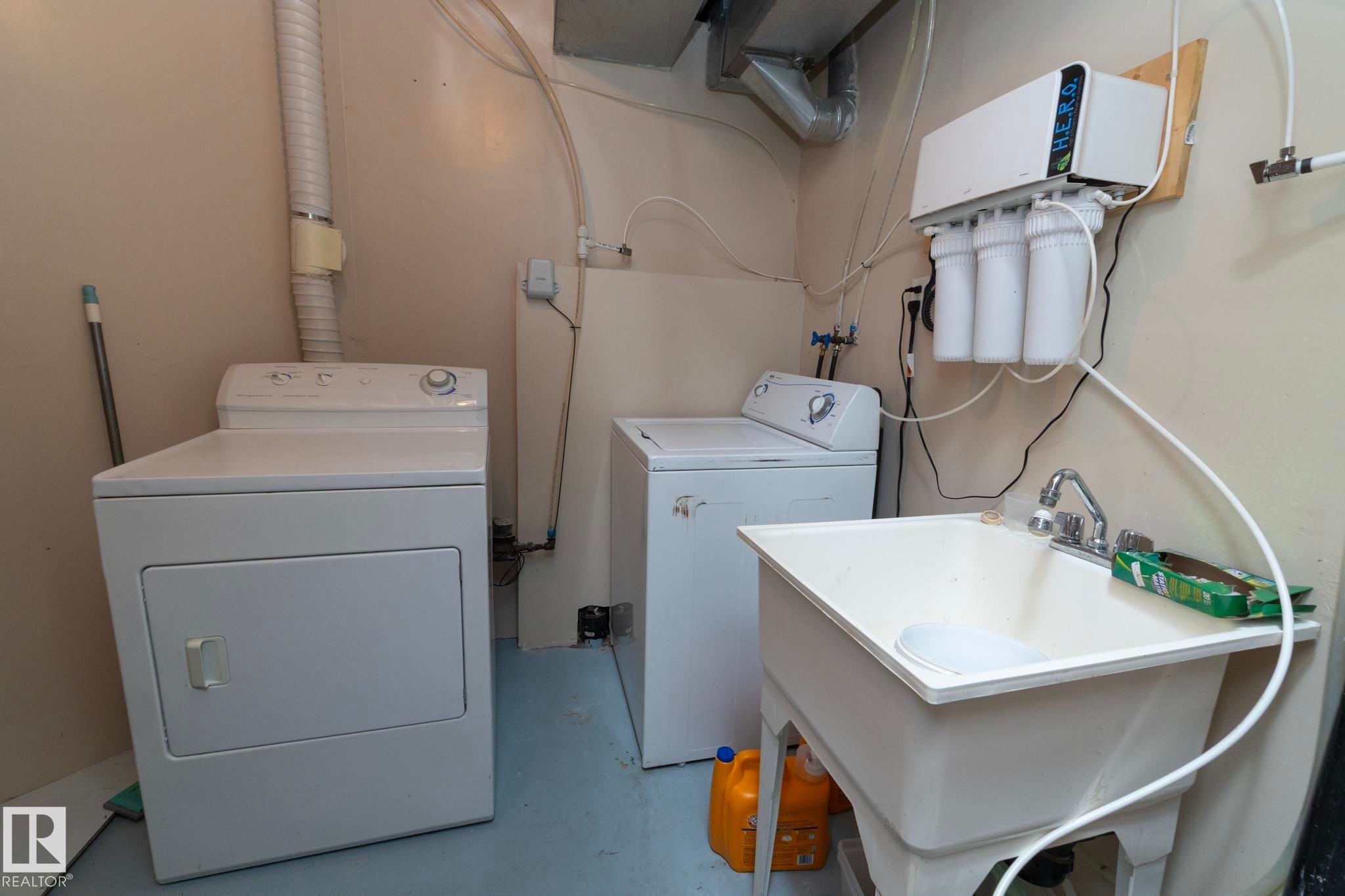 Laundry area with utility sink, water filtration system, and exposed ductwork - #37 3811 85 St Nw, Edmonton, AB