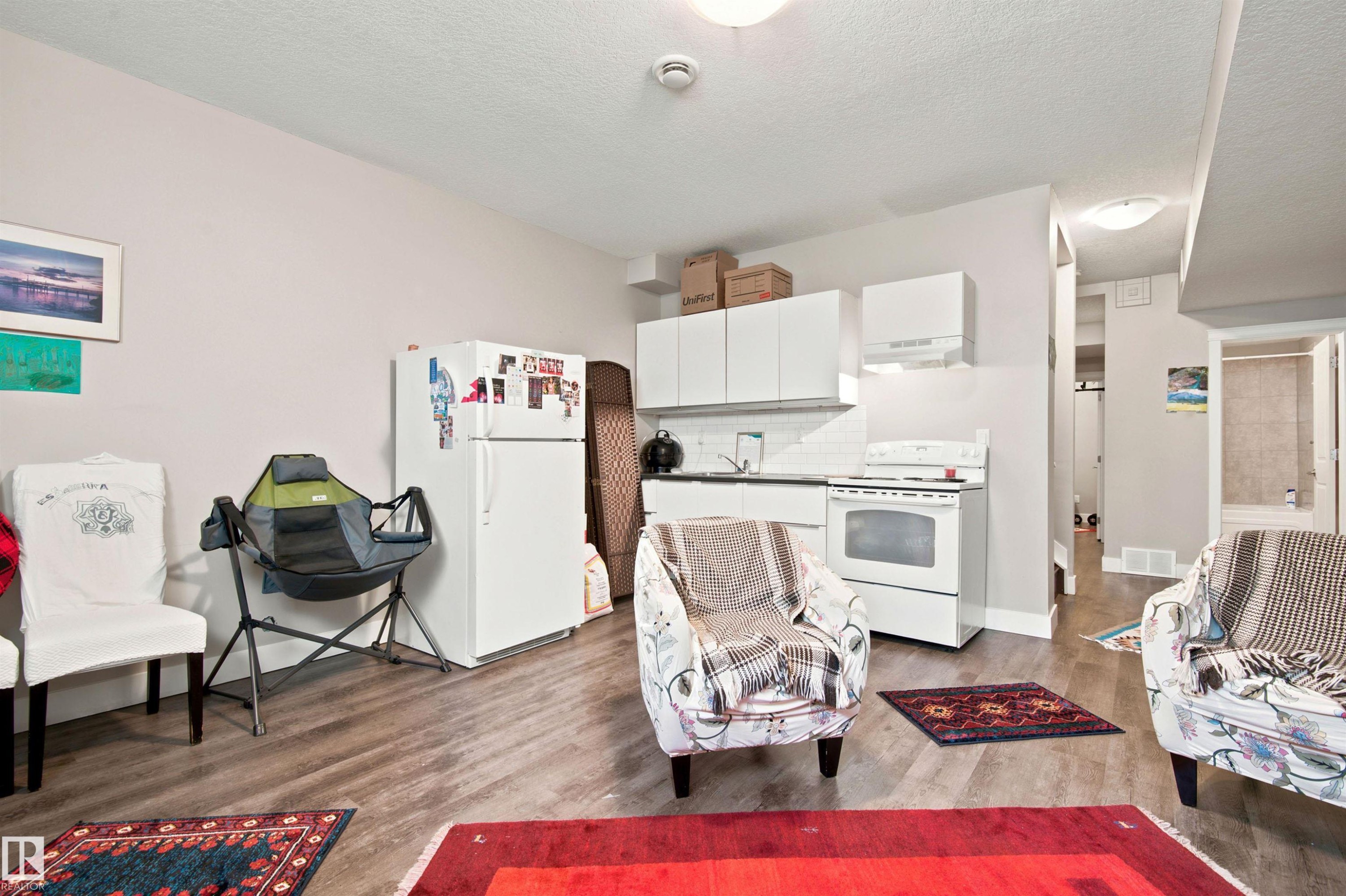 Open-concept living space with wood-finish flooring - 10833 63 Avenue Nw, Edmonton, AB