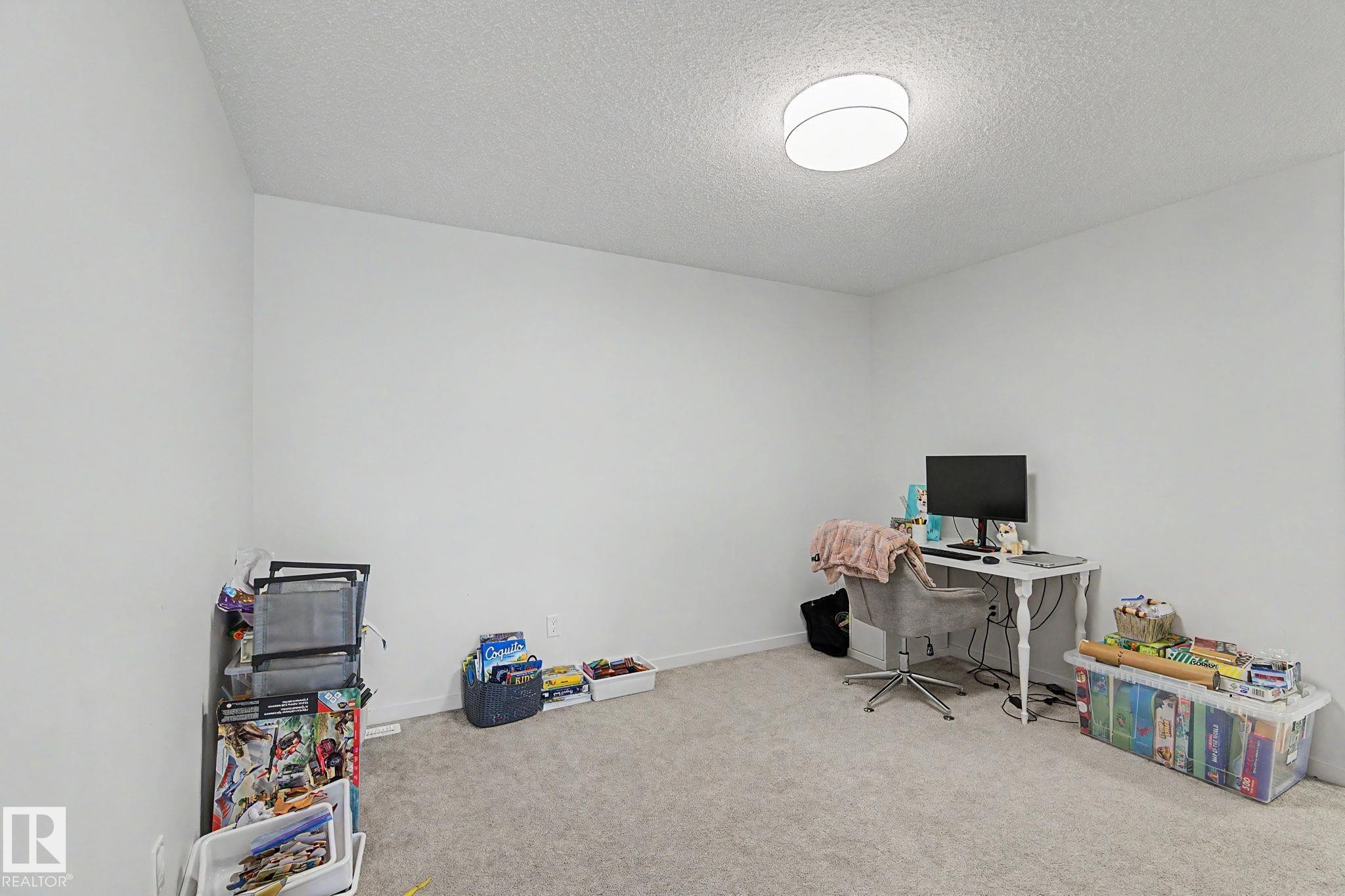 Room with light-colored carpeting and white walls - #12 905 172 St Sw, Edmonton, AB - Indoor Photo Showing Office