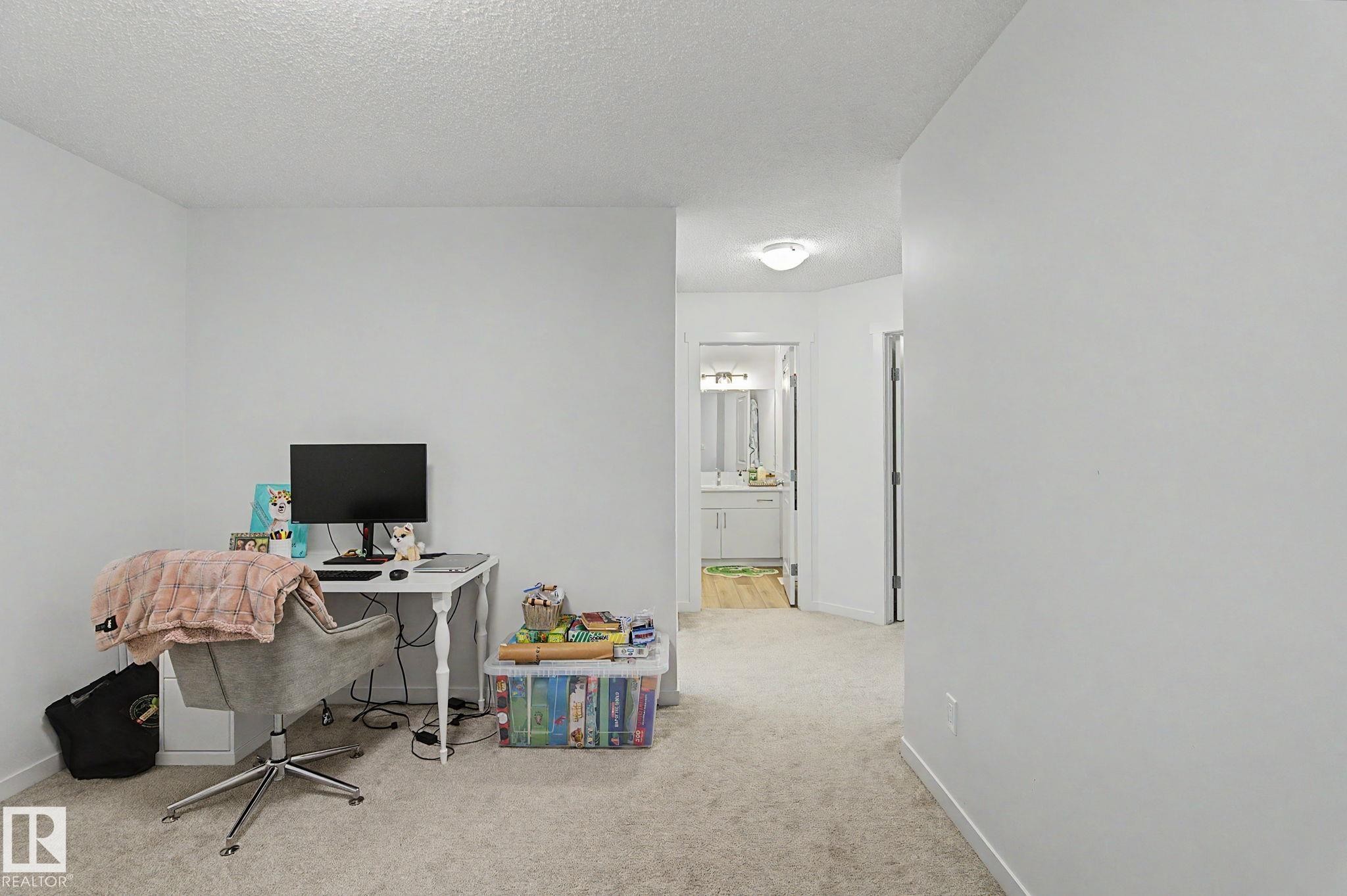 Carpeted interior space with a neutral color palette - #12 905 172 St Sw, Edmonton, AB - Indoor Photo Showing Office