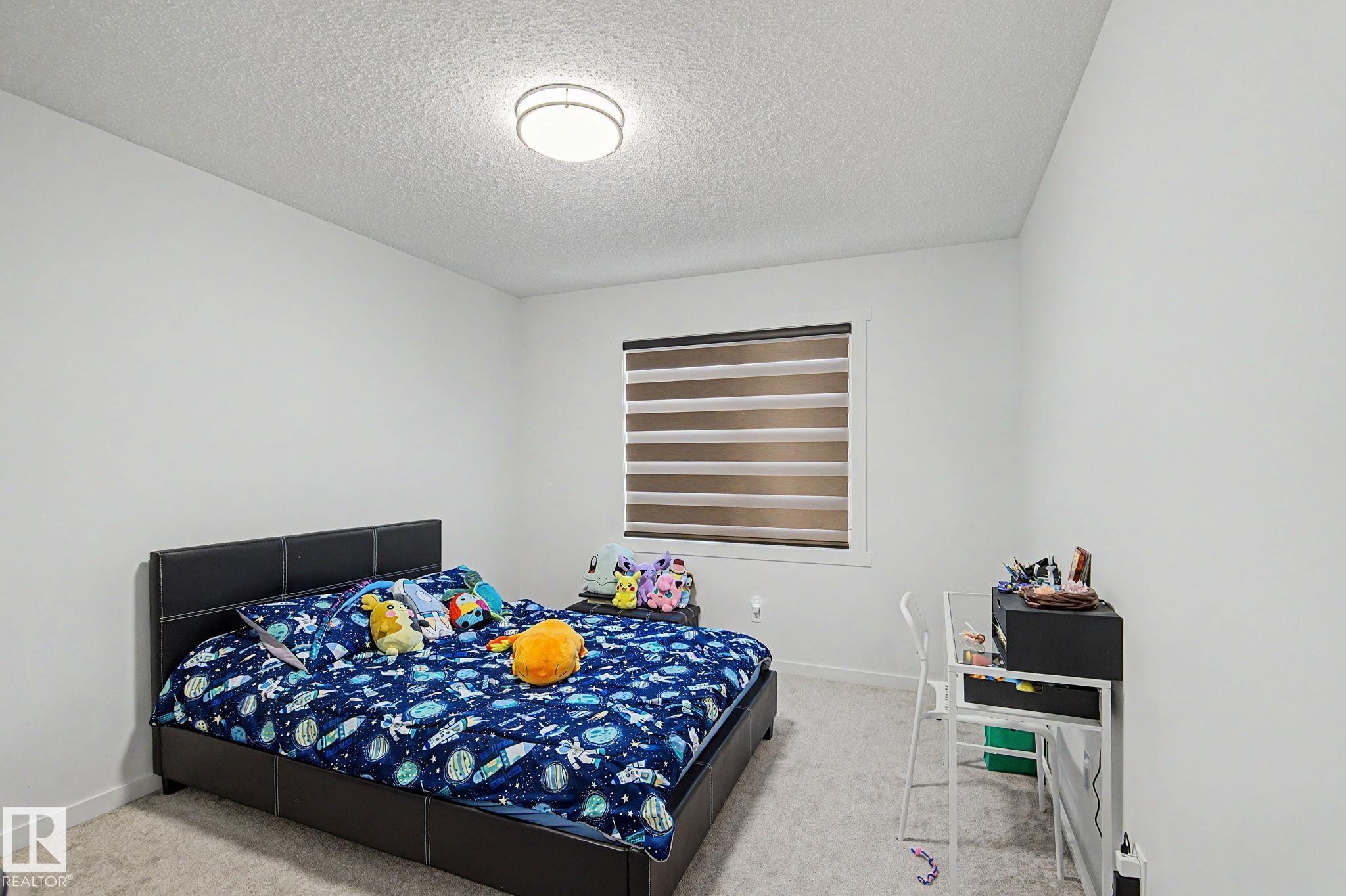 Spacious room featuring neutral carpeting and white walls - #12 905 172 St Sw, Edmonton, AB - Indoor Photo Showing Bedroom