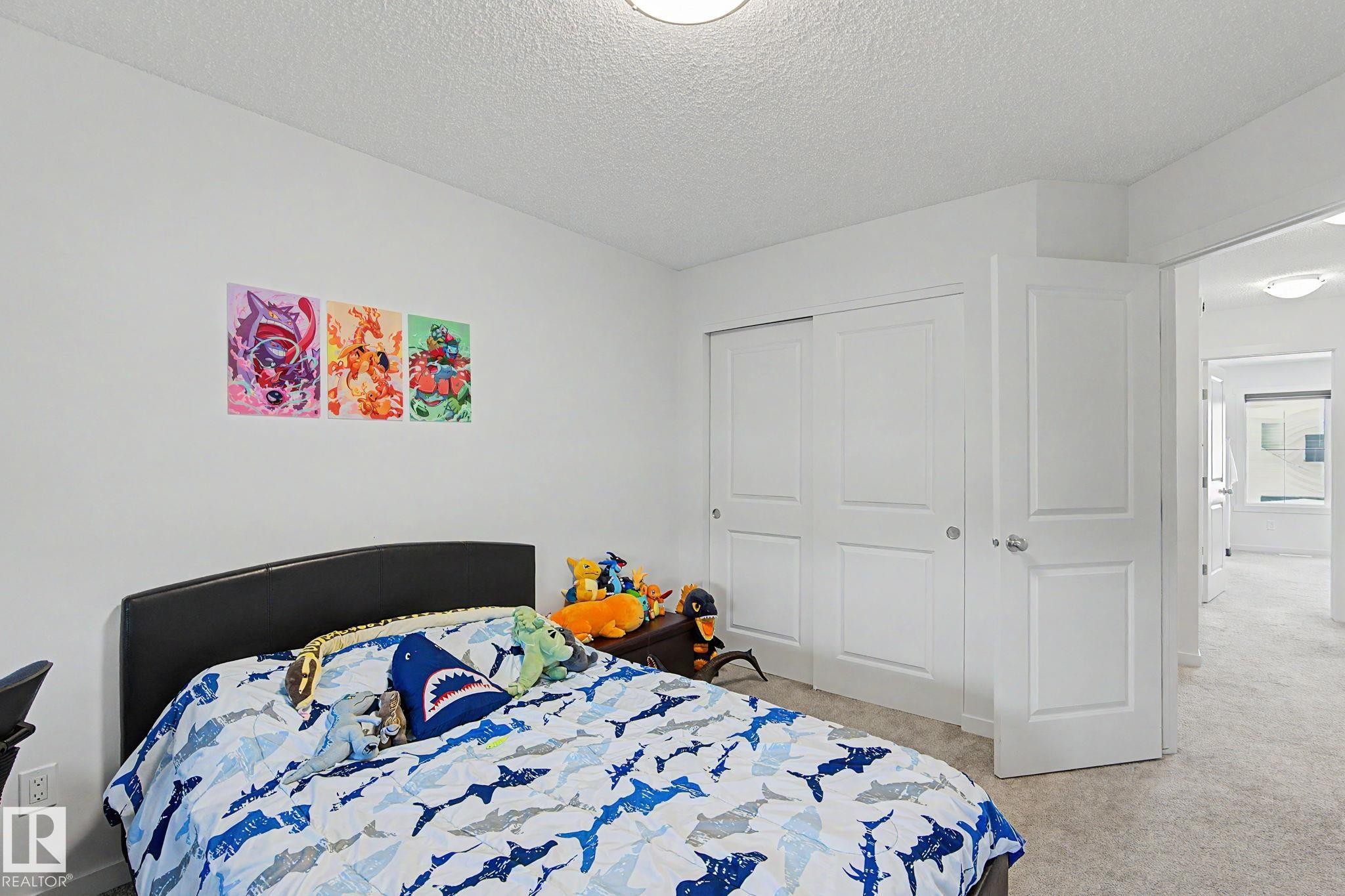 Neutral wall paint, plush carpet flooring, recessed lighting, and white paneled doors - #12 905 172 St Sw, Edmonton, AB - Indoor Photo Showing Bedroom