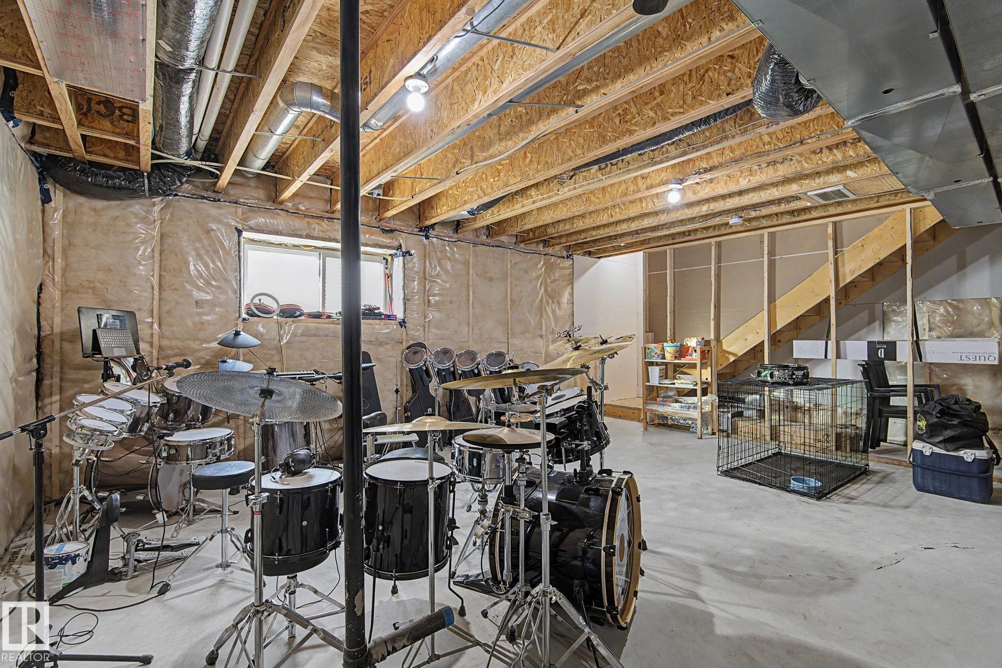 Unfinished basement with exposed ceiling joists and visible ductwork - #12 905 172 St Sw, Edmonton, AB - Indoor Photo Showing Basement