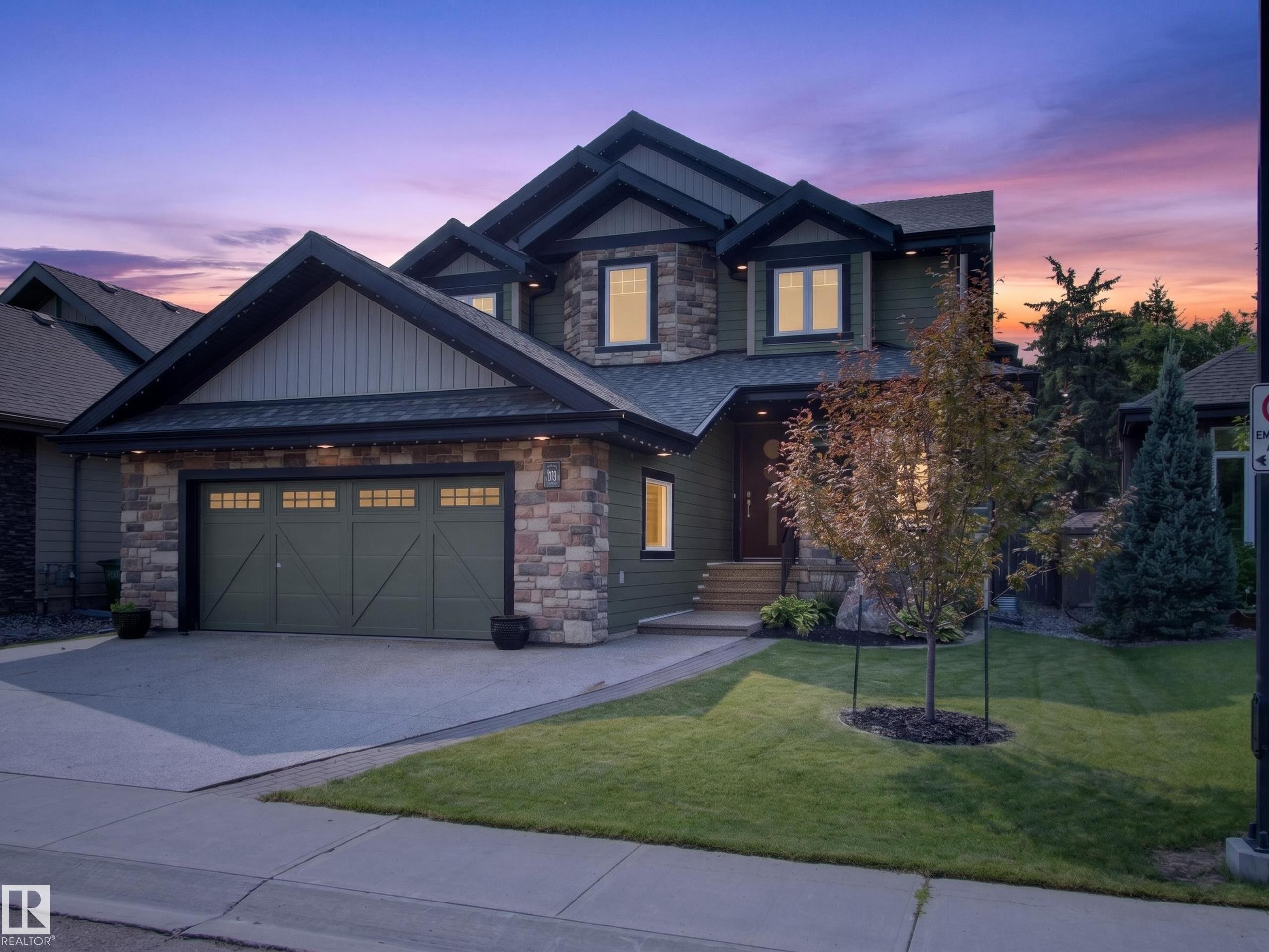 Stone and siding exterior with dark trim accents - #59 10550 Ellerslie Rd Sw, Edmonton, AB - Outdoor With Facade
