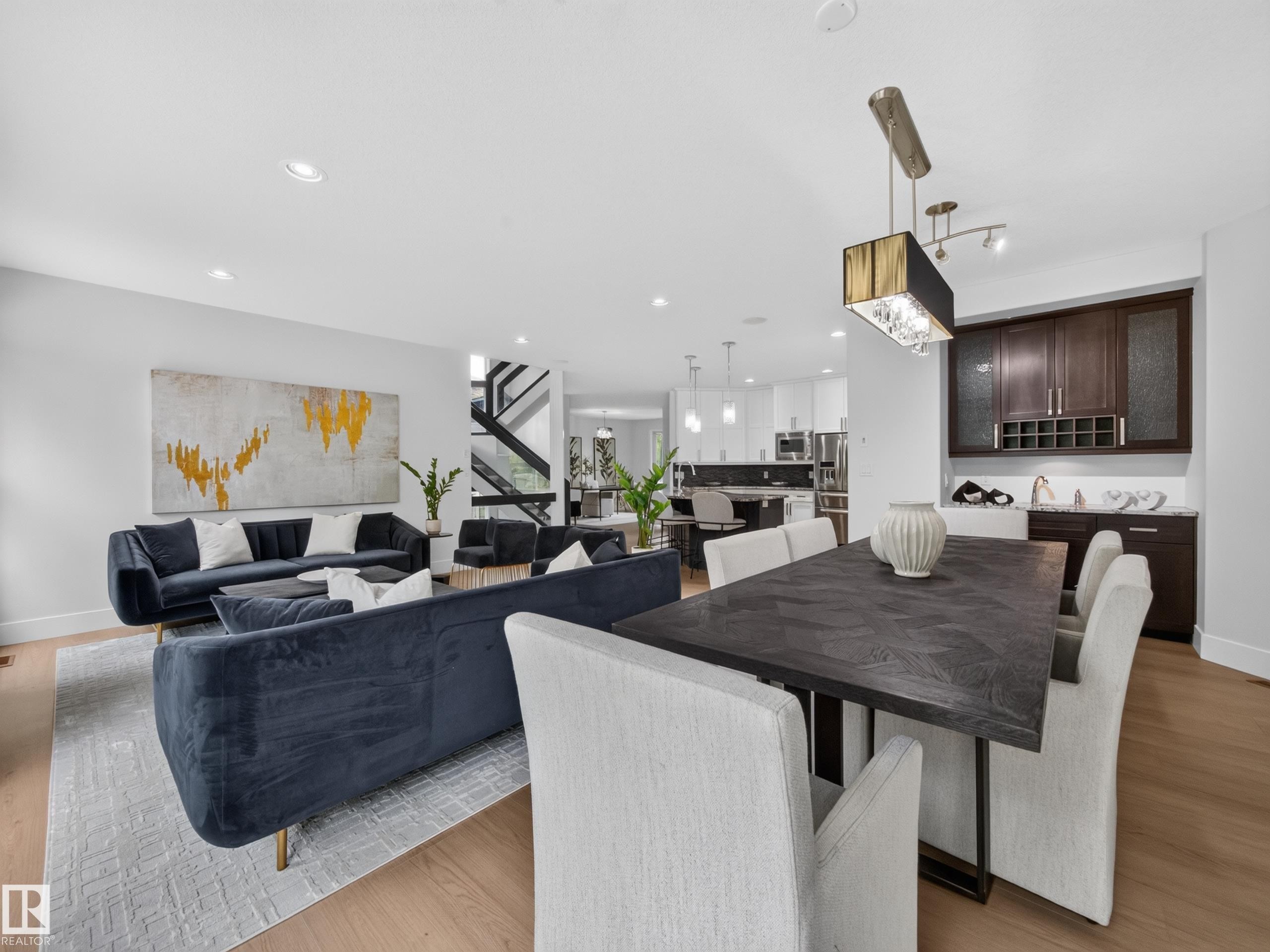 Open-concept living space with light wood-finish flooring - #59 10550 Ellerslie Rd Sw, Edmonton, AB - Indoor