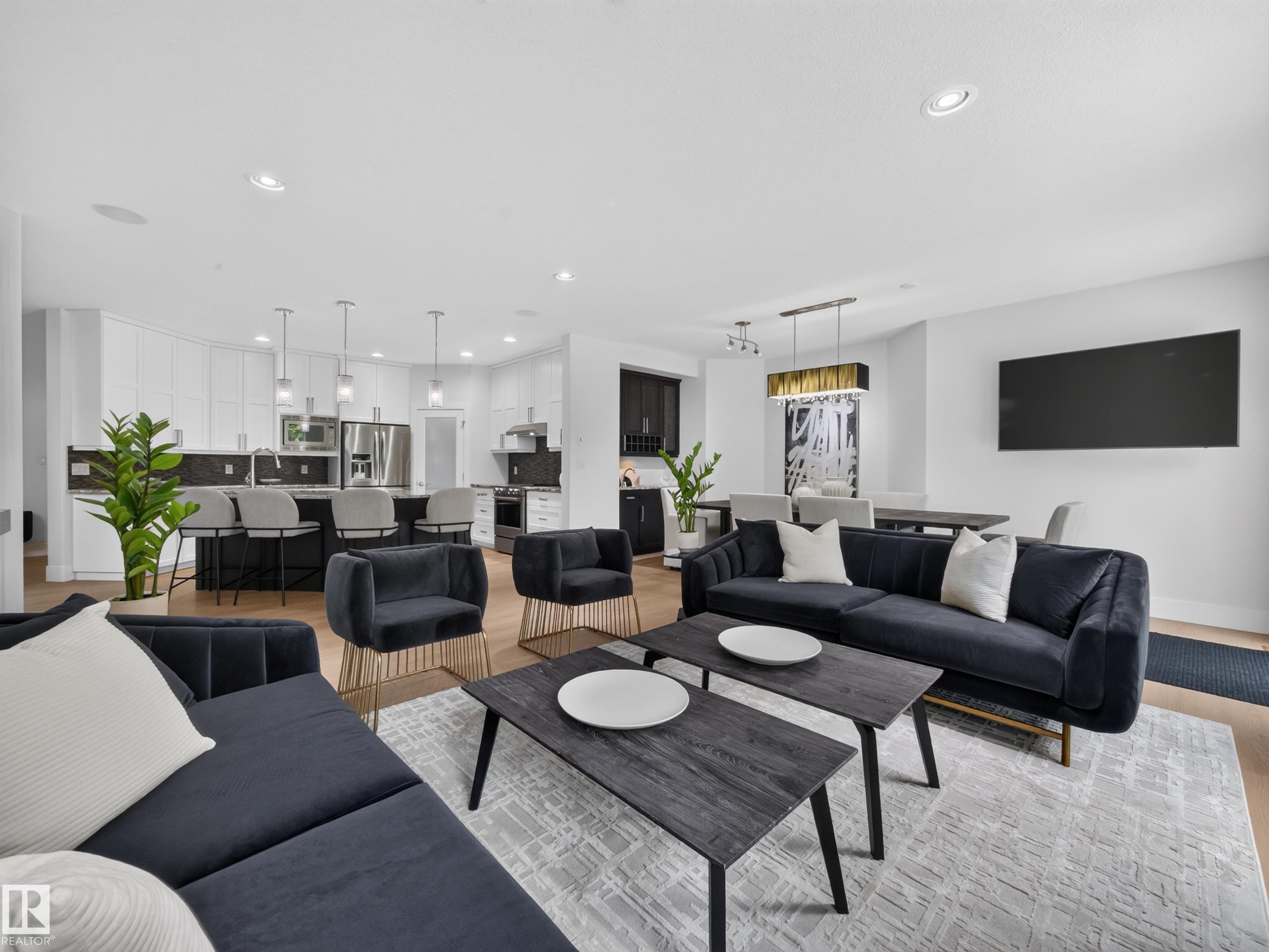 Open-concept living space featuring wood-finish flooring throughout - #59 10550 Ellerslie Rd Sw, Edmonton, AB - Indoor Photo Showing Living Room