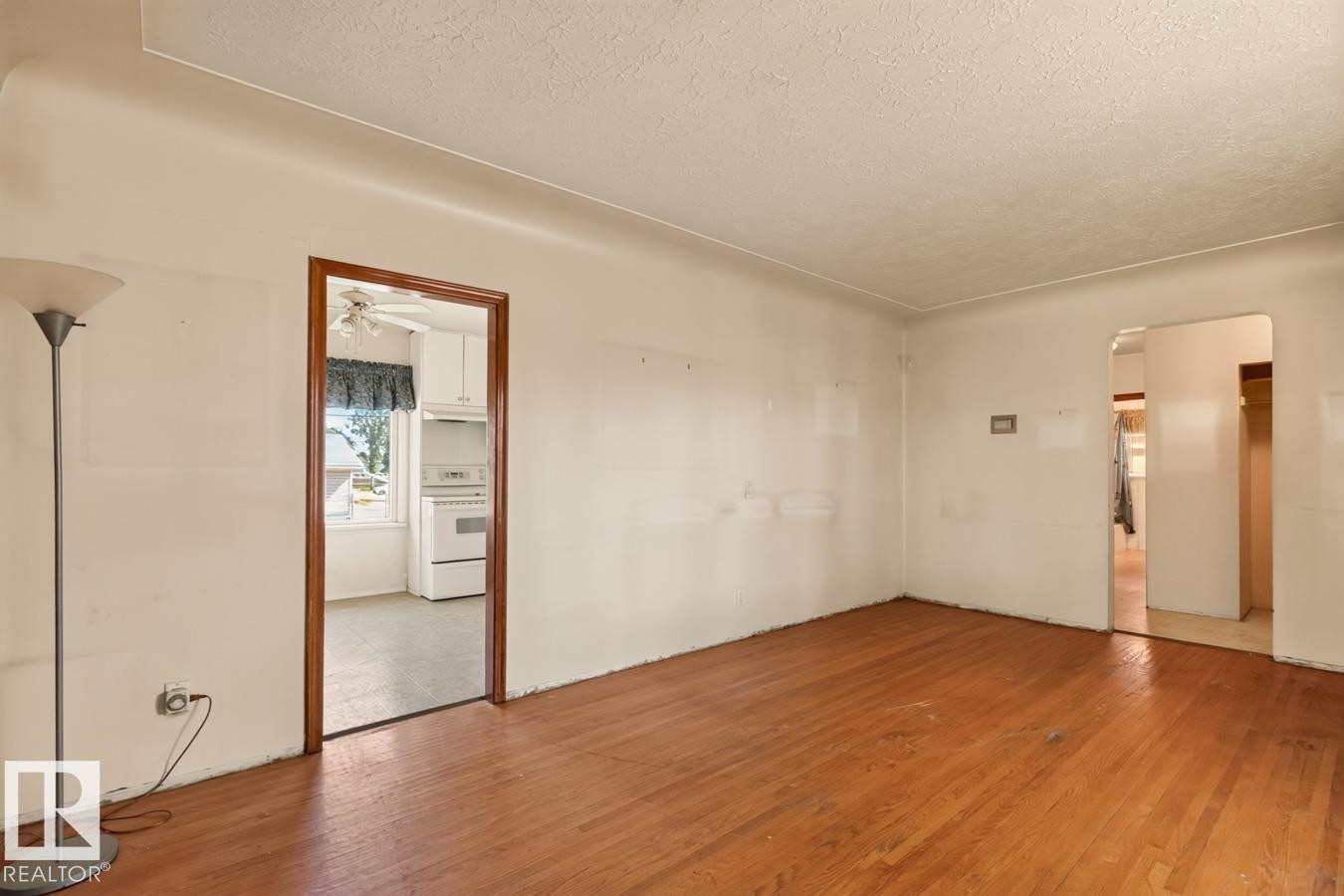 Wood-finish flooring with white walls and natural light - 12309 128 Street Nw, Edmonton, AB