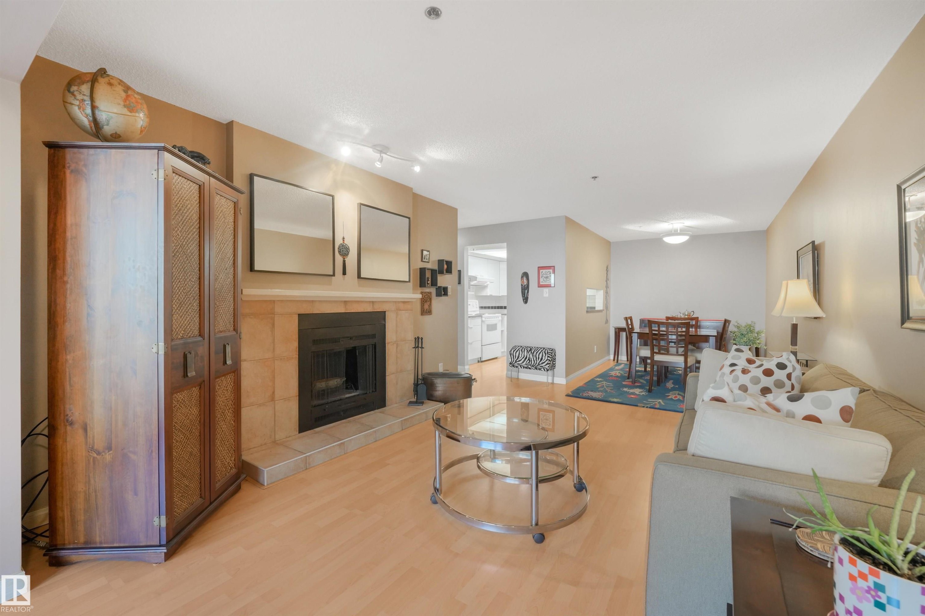 Tiled fireplace with a wood mantle - #203 10171 119 St Nw, Edmonton, AB