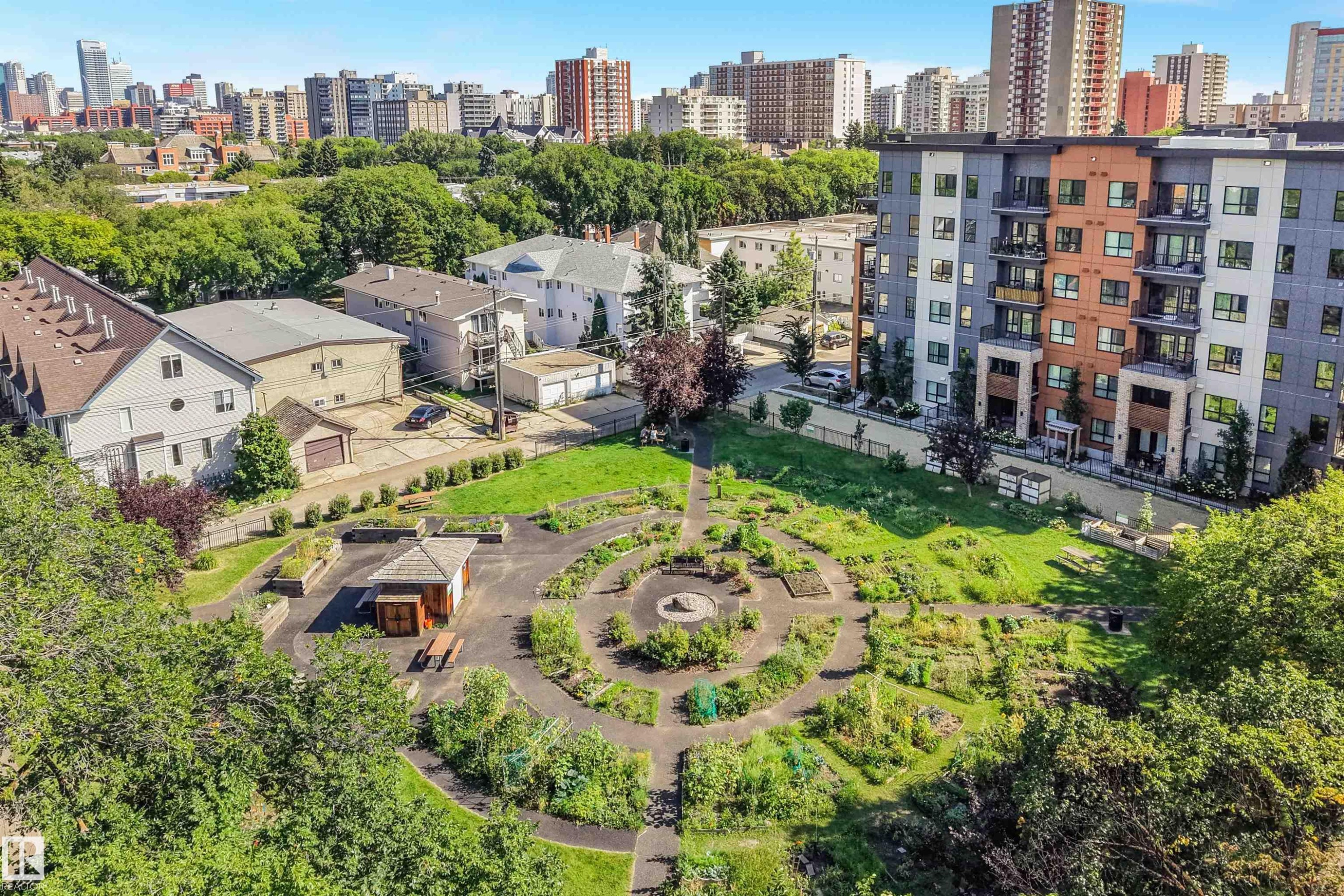 Landscaped communal garden with winding paths, a central gazebo, and various plantings - #203 10171 119 St Nw, Edmonton, AB