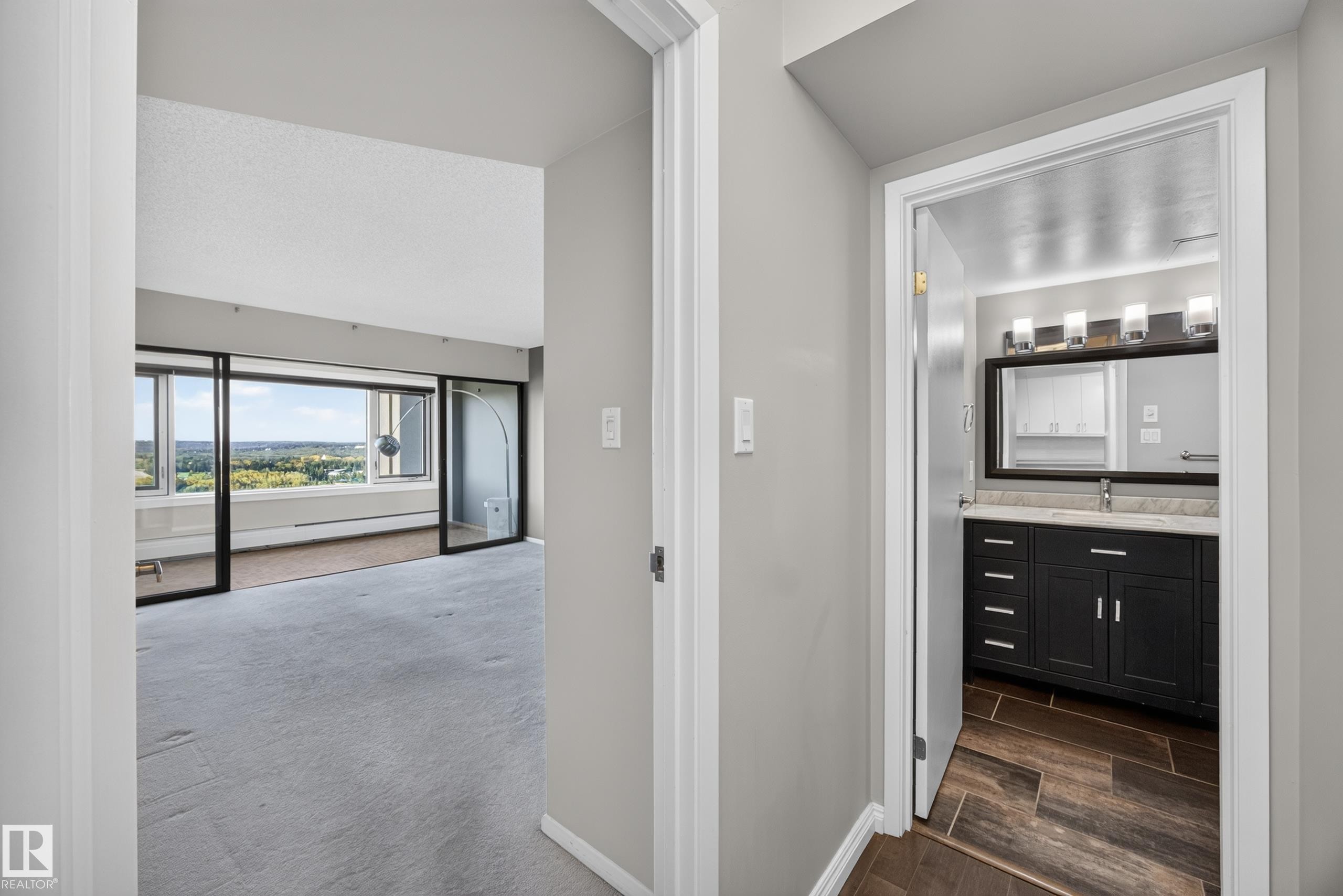 Hallway between the front entry, bedroom, storage, and bathroom space. - #803 10011 123 St Nw, Edmonton, AB