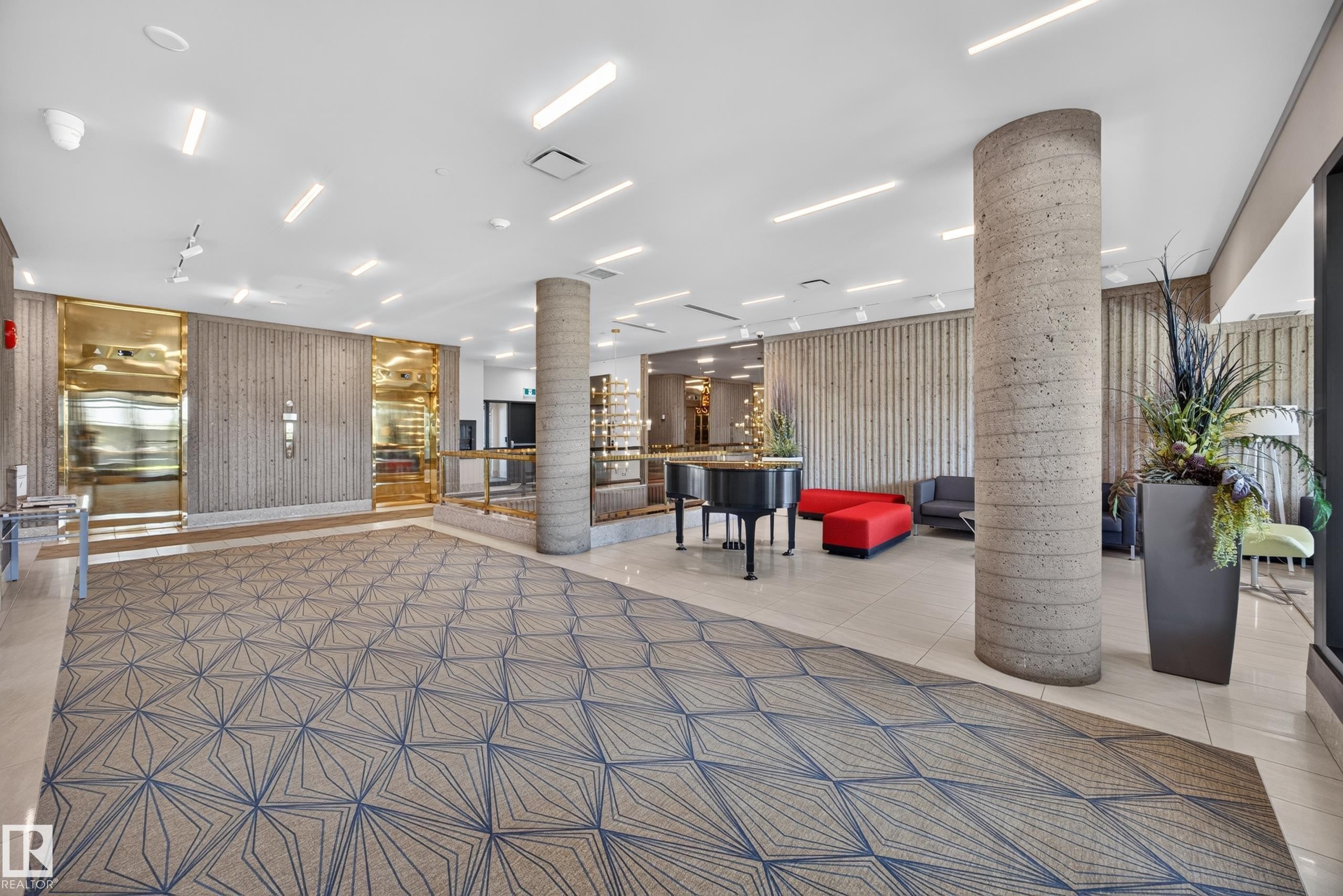 Lobby of the Condo Building featuring seating area, grand piano, mailboxes, and on site manager office. - #803 10011 123 St Nw, Edmonton, AB