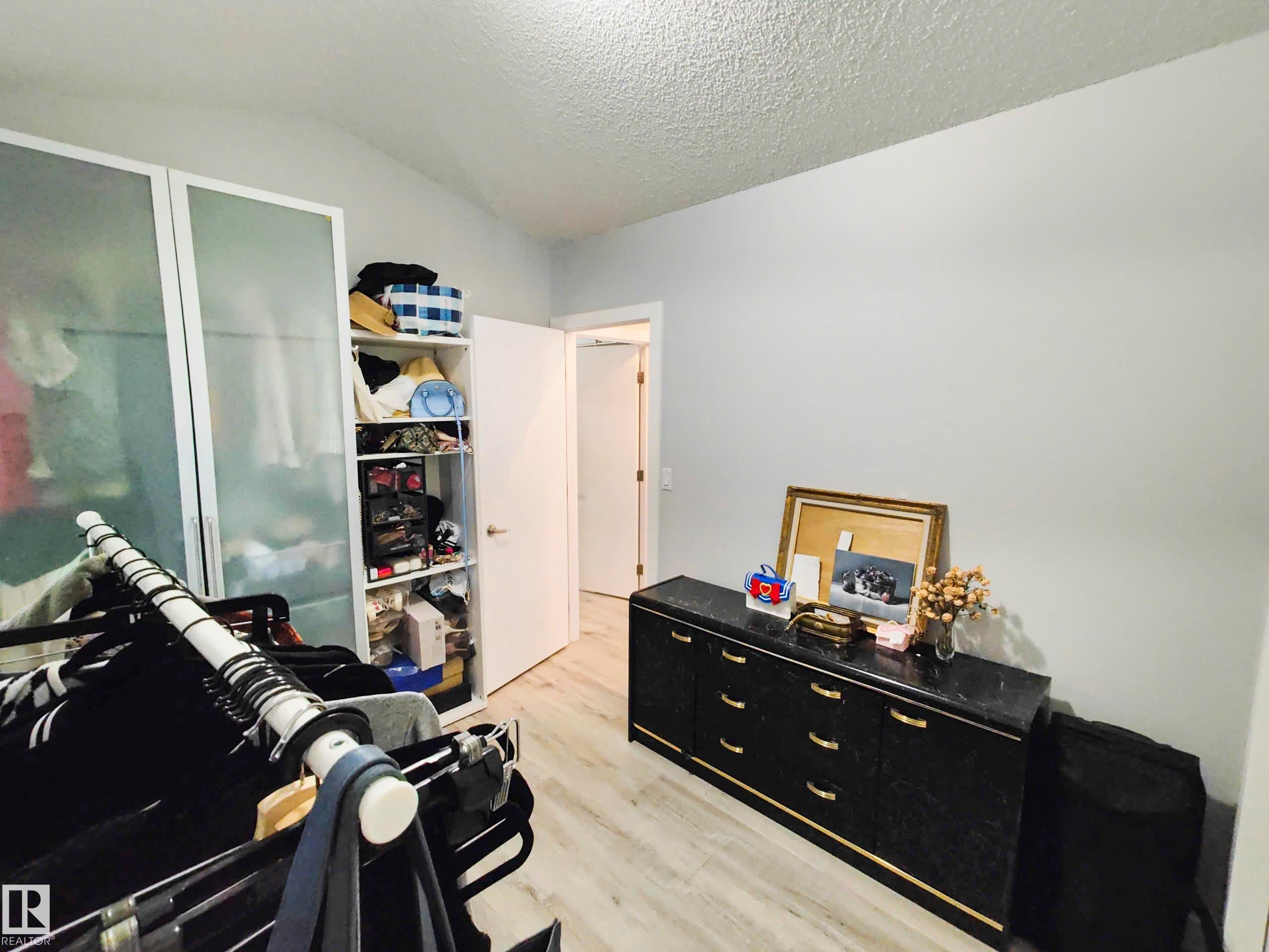 Light wood-finish flooring with white walls and a vaulted ceiling - 215 Peter Close Nw, Edmonton, AB