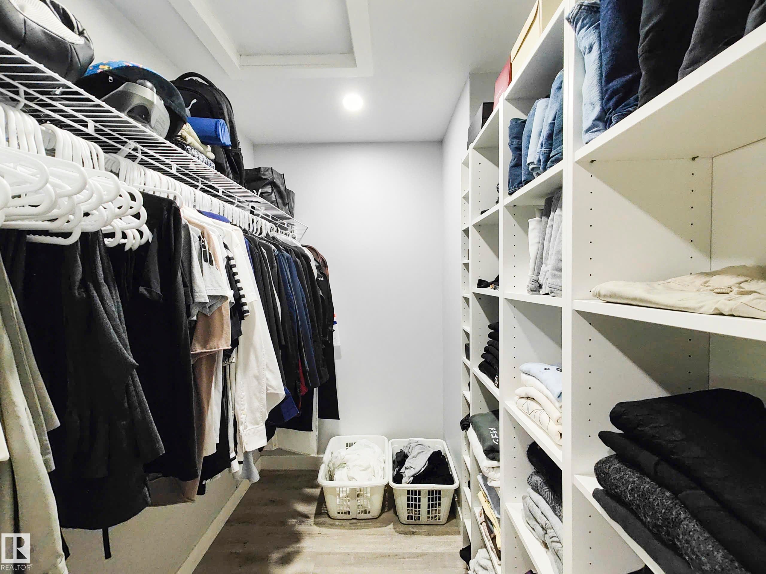 Recessed lighting, wood-finish flooring, built-in shelving, wire shelving, and white walls - 215 Peter Close Nw, Edmonton, AB