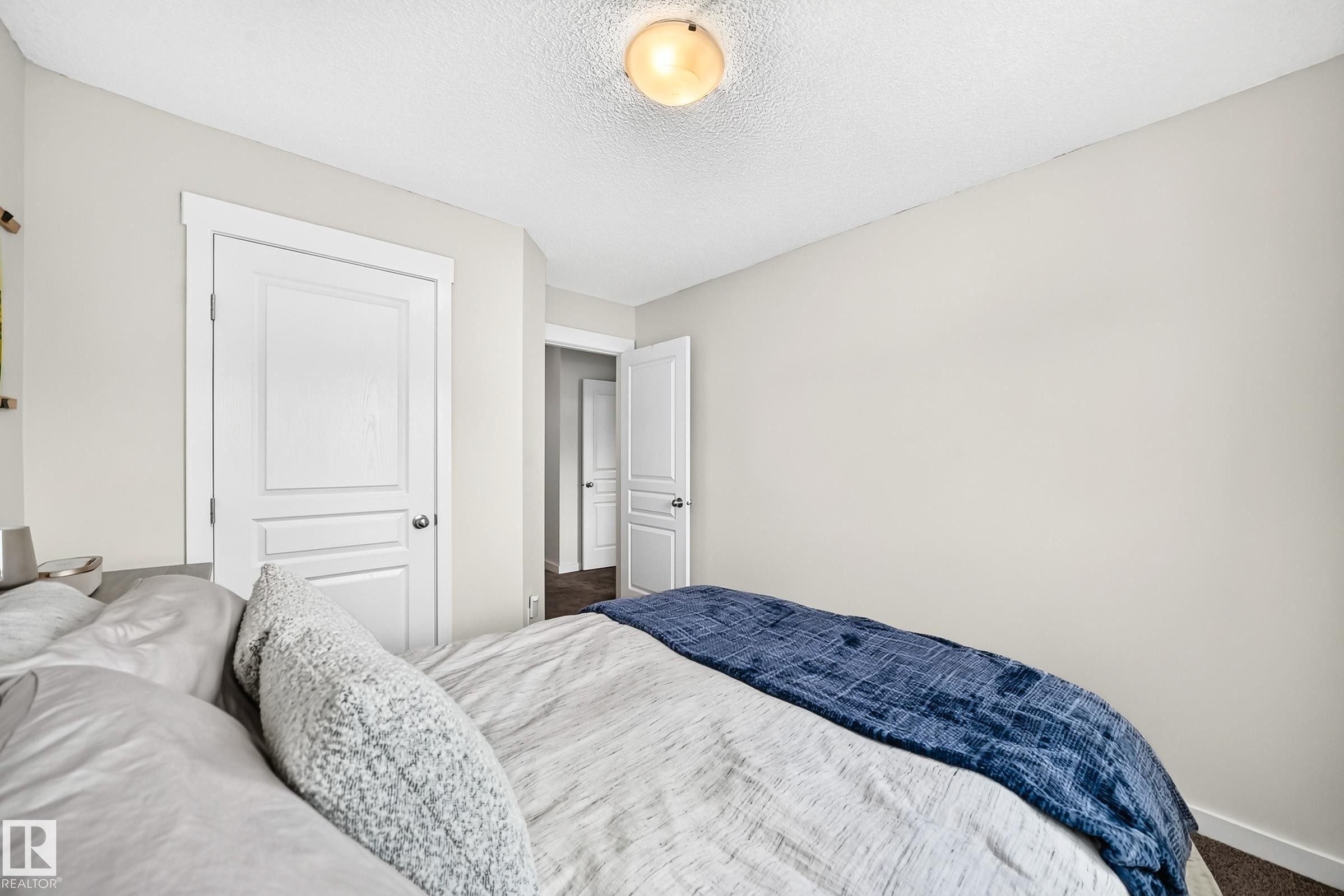 White interior doors with panel detailing, white trim, and light neutral wall paint - 16832 53 Street Nw, Edmonton, AB
