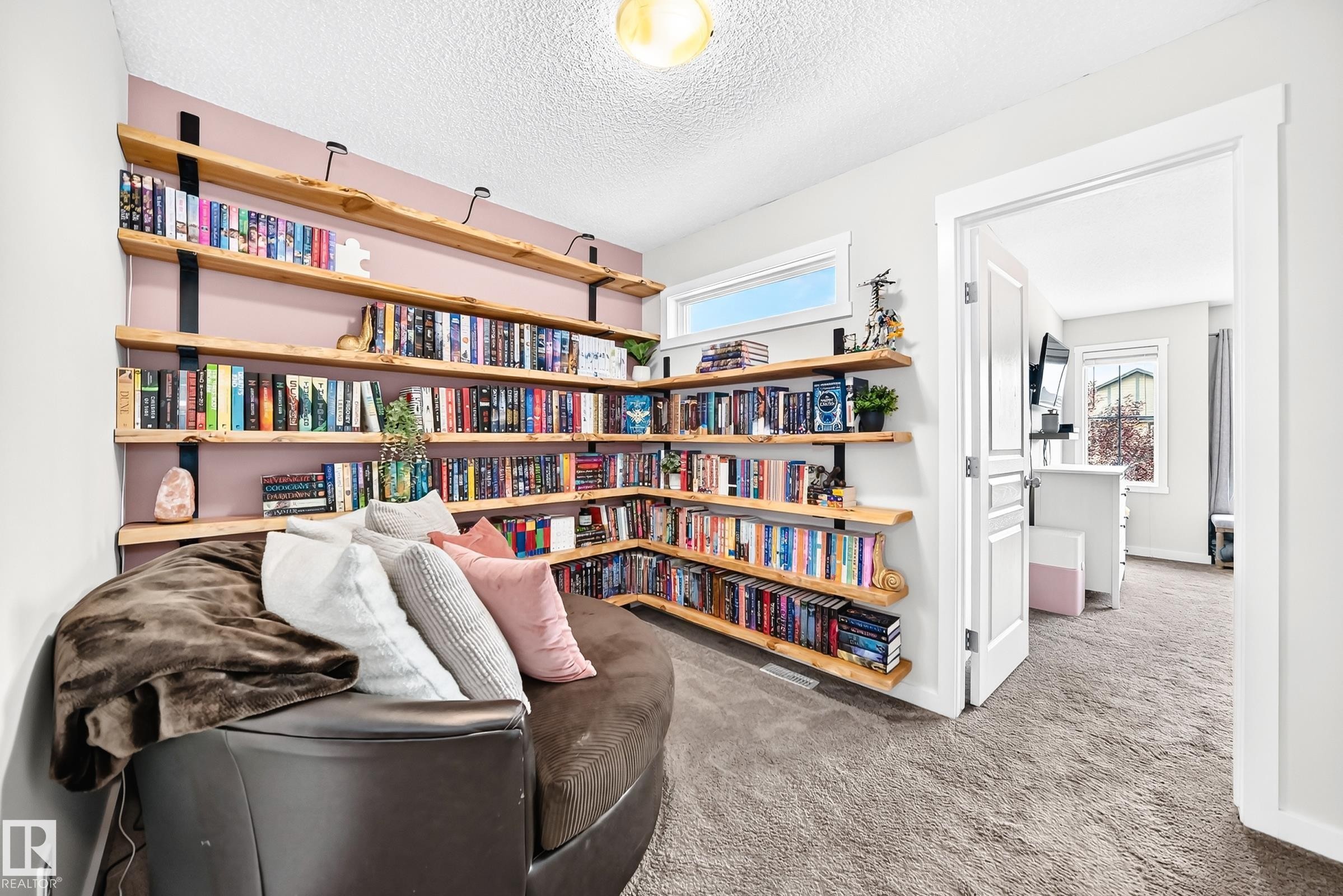 Built-in shelving with wood-finish planks, recessed window, and white trim - 16832 53 Street Nw, Edmonton, AB
