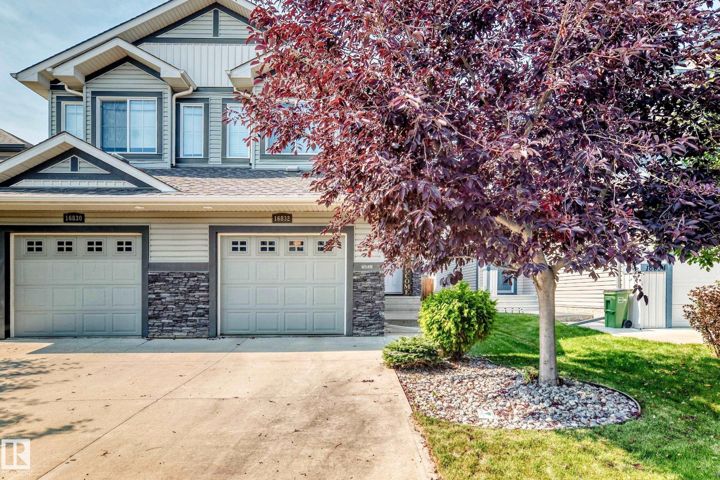 Multi-level façade with horizontal siding and stacked stone accents - 16832 53 Street Nw, Edmonton, AB