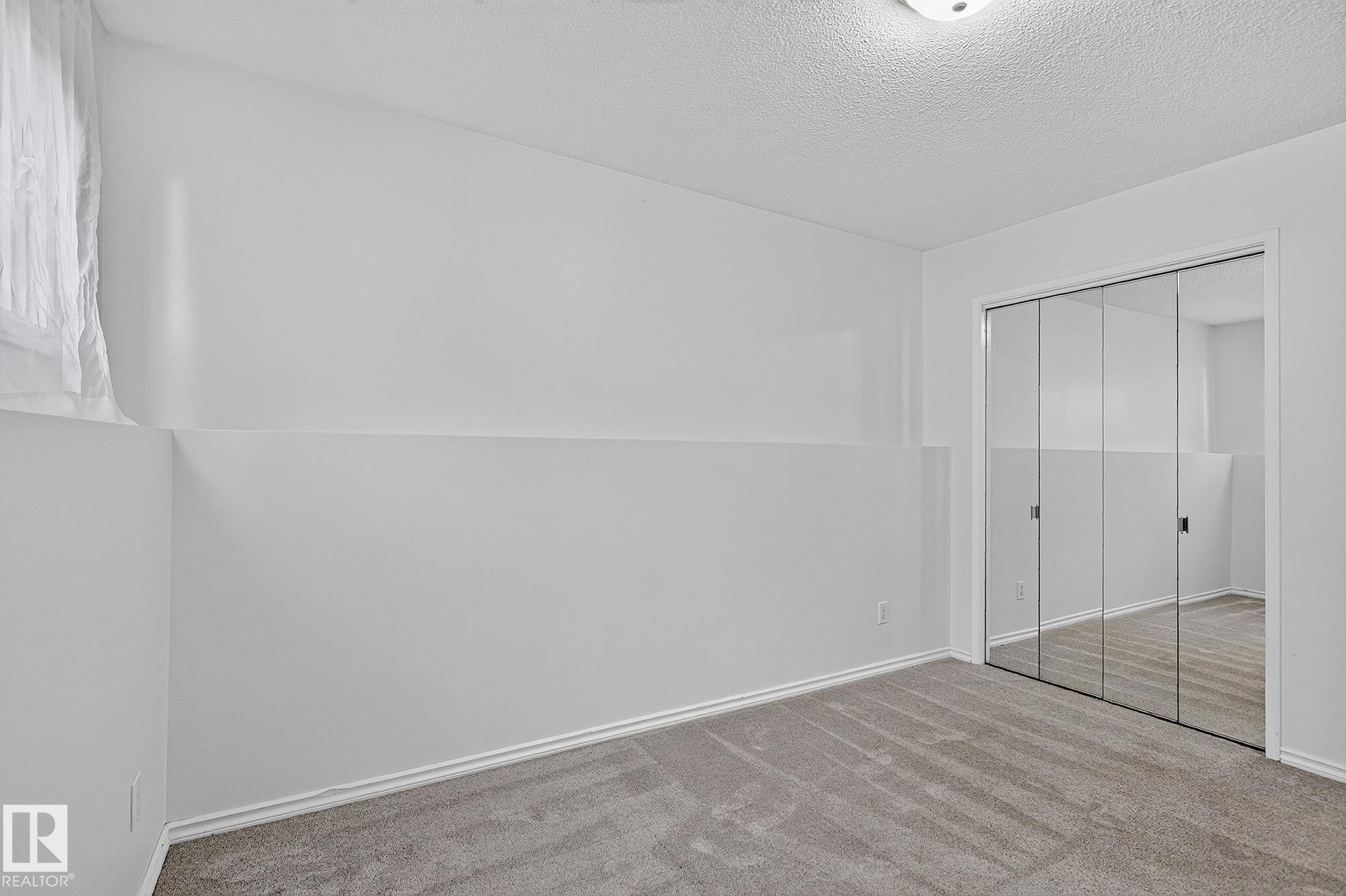 Carpeted flooring, mirrored sliding closet doors, and recessed lighting - 16016 78A Avenue Nw, Edmonton, AB