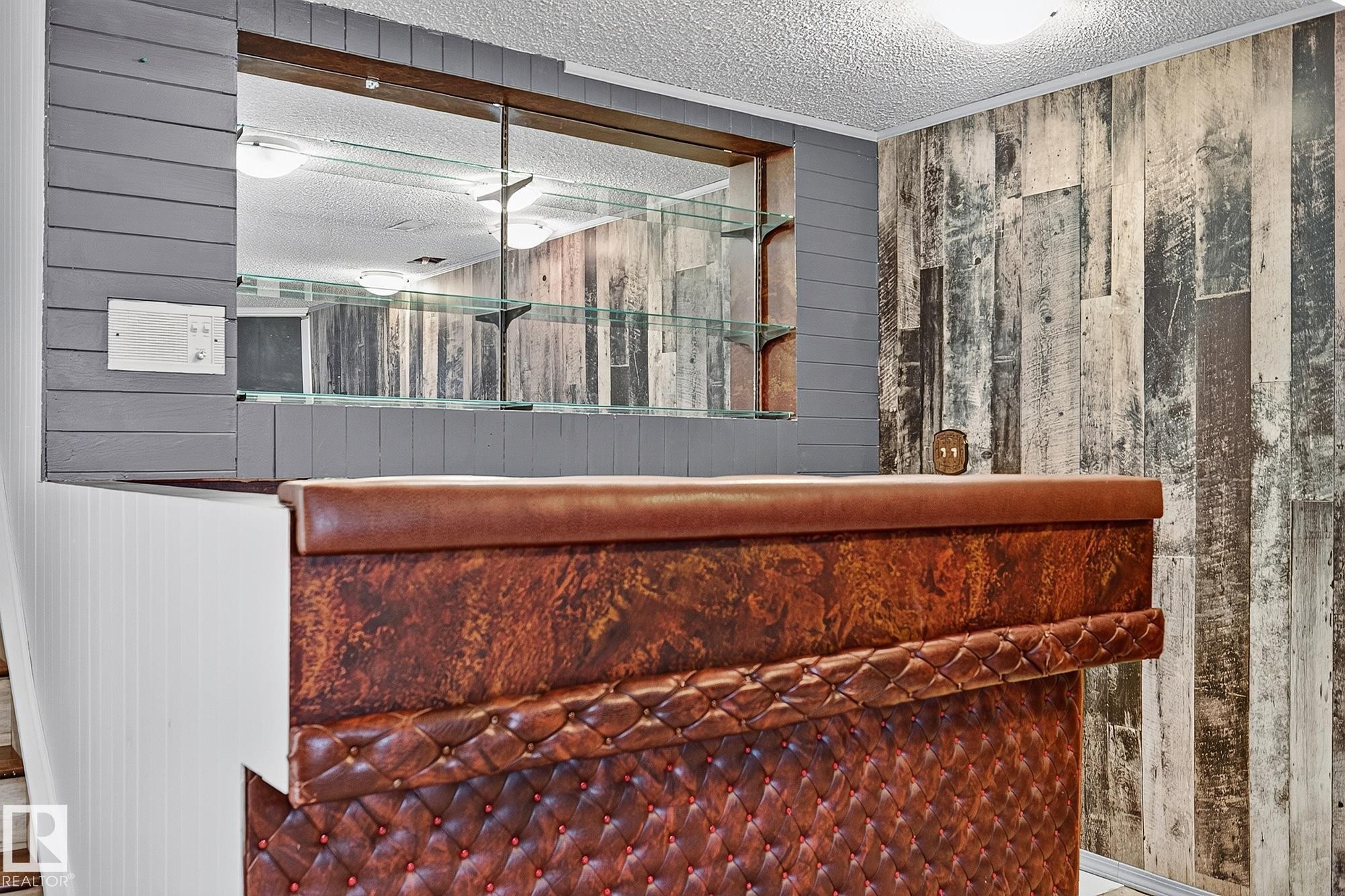 Built-in bar featuring a tufted leatherette front and a polished top - 16016 78A Avenue Nw, Edmonton, AB