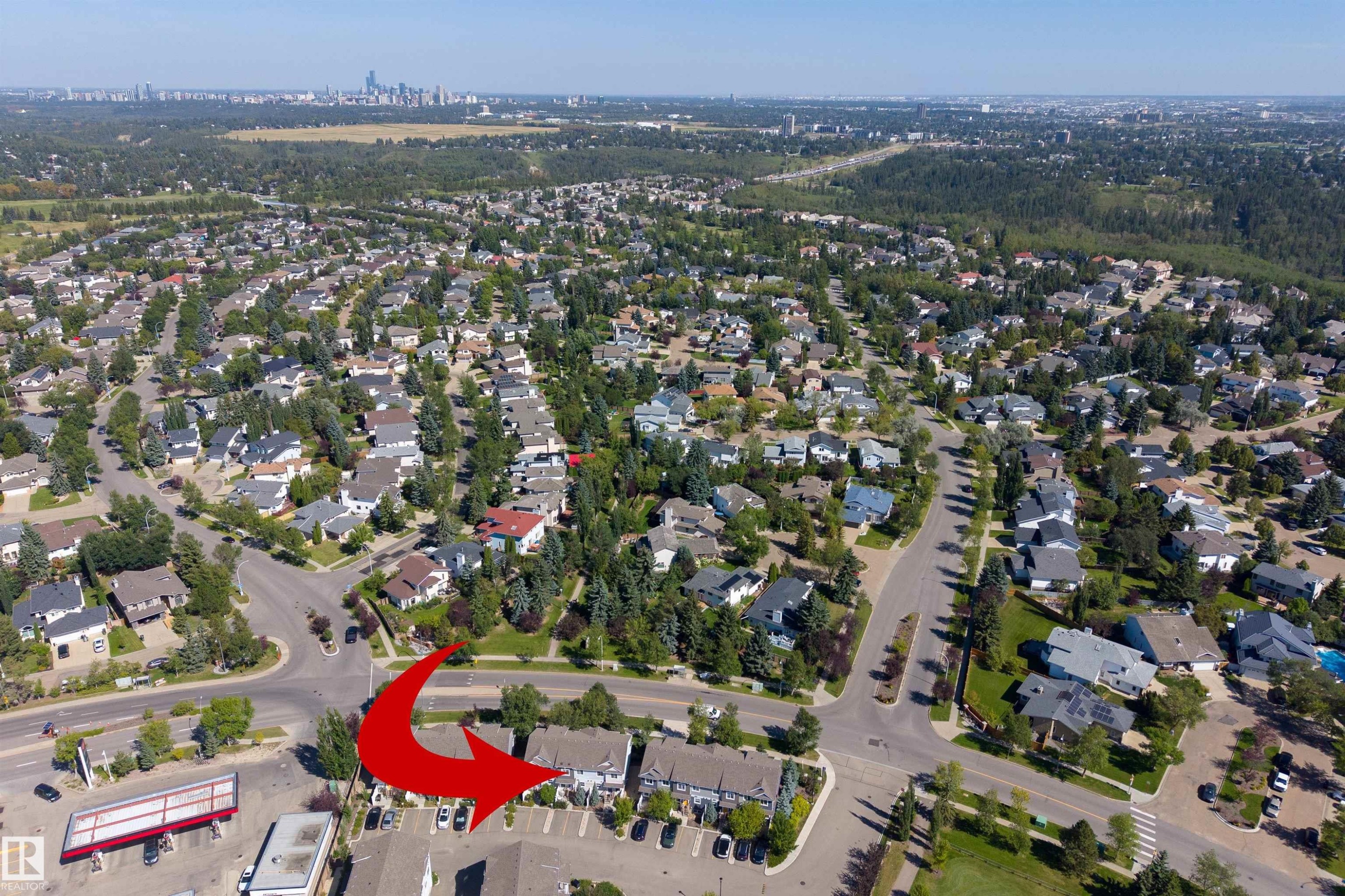 Aerial perspective showcasing a residential neighborhood with a distant cityscape - #71 330 Bulyea Rd Nw, Edmonton, AB