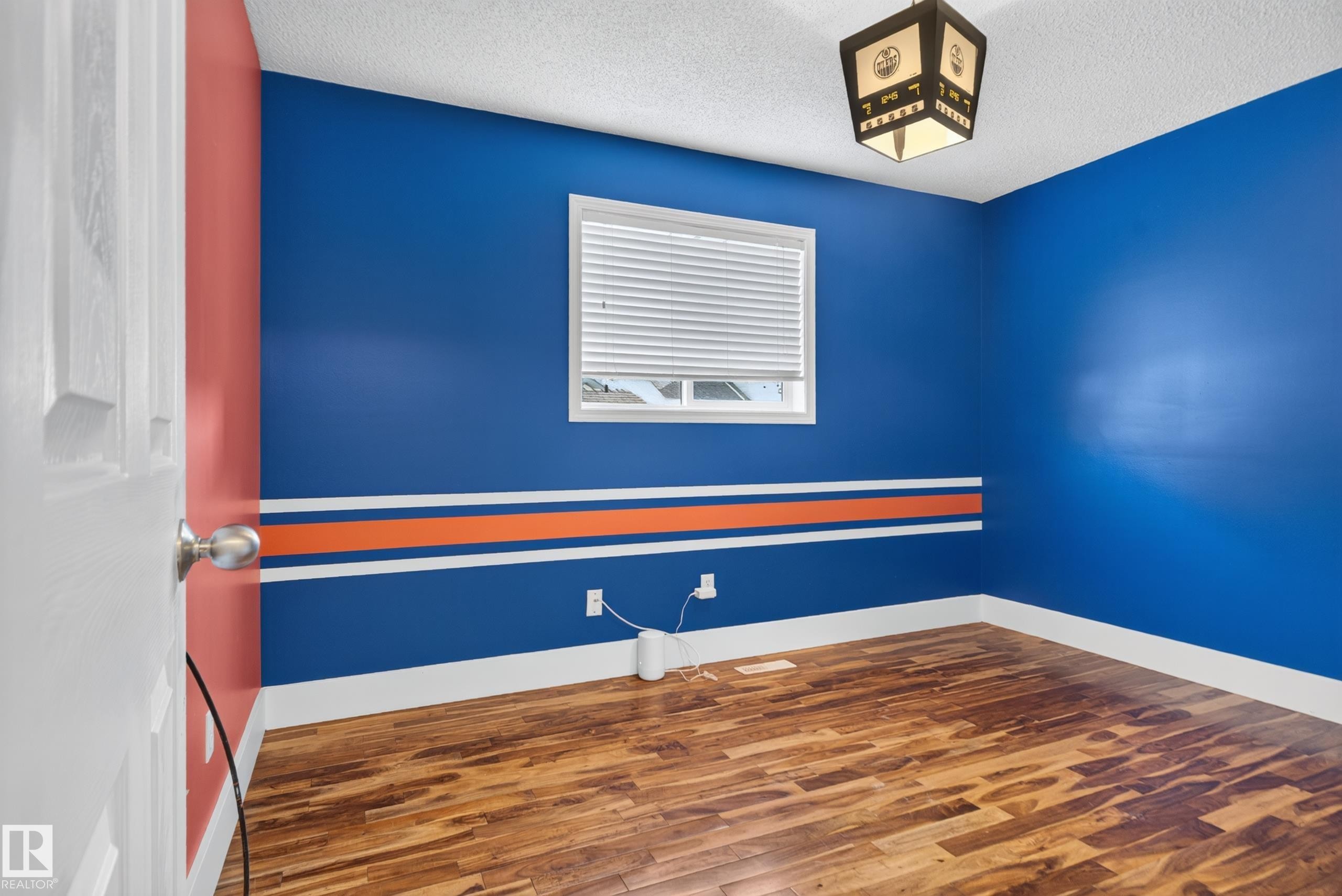 Wood-finish flooring with white trim - 13803 130A Avenue Nw, Edmonton, AB