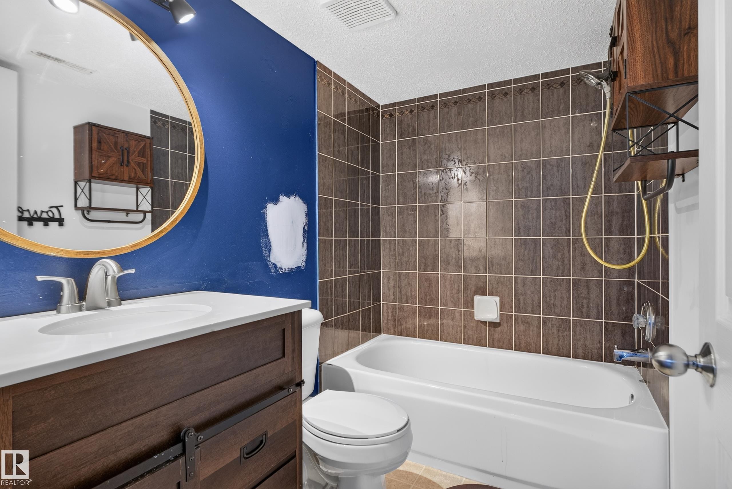 Dark wood-finish vanity with a white countertop and undermount sink - 13803 130A Avenue Nw, Edmonton, AB