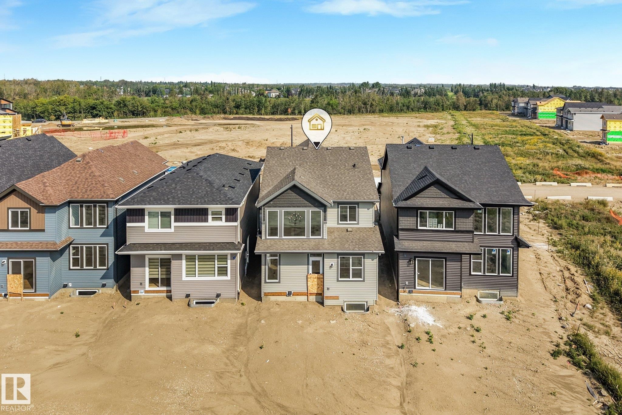 Multi-story residence featuring a gabled roof and a combination of horizontal and vertical exterior siding - 511 157 Avenue Ne, Edmonton, AB