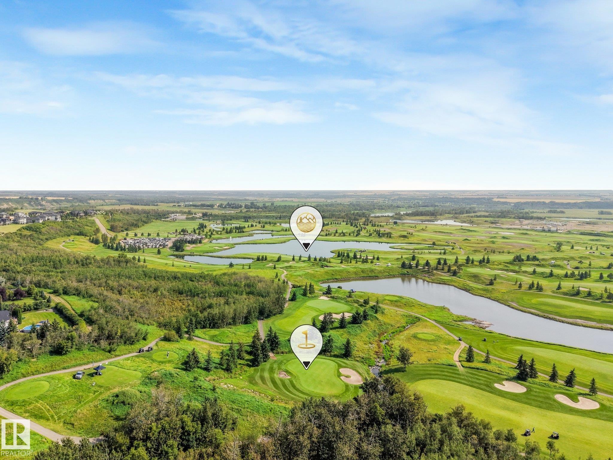 Aerial perspective showcasing expansive golf course, mature trees, and multiple water features - 511 157 Avenue Ne, Edmonton, AB