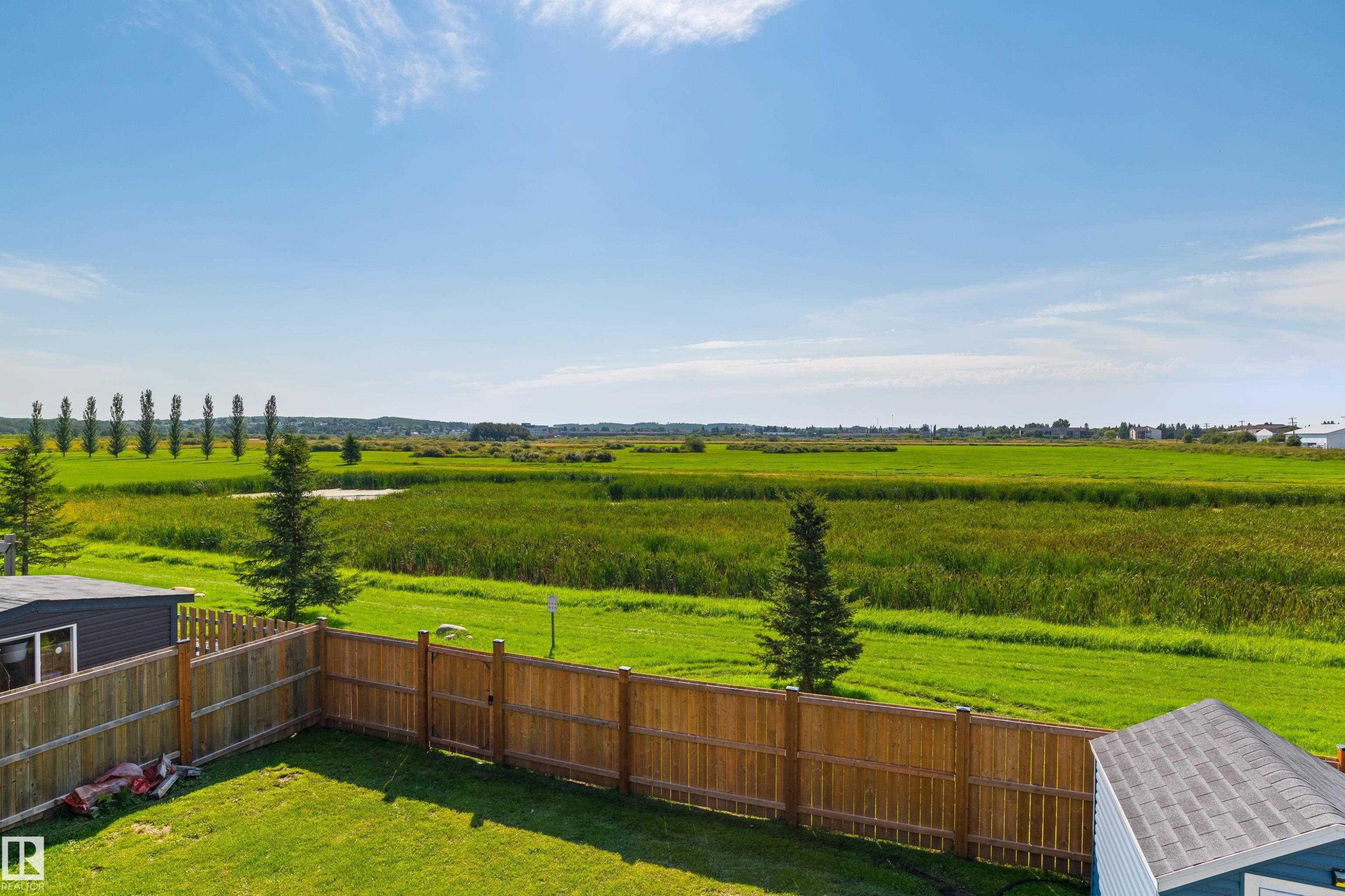 Expansive green space and open fields extending into the distance - 4927 57 Avenue, Cold Lake, AB
