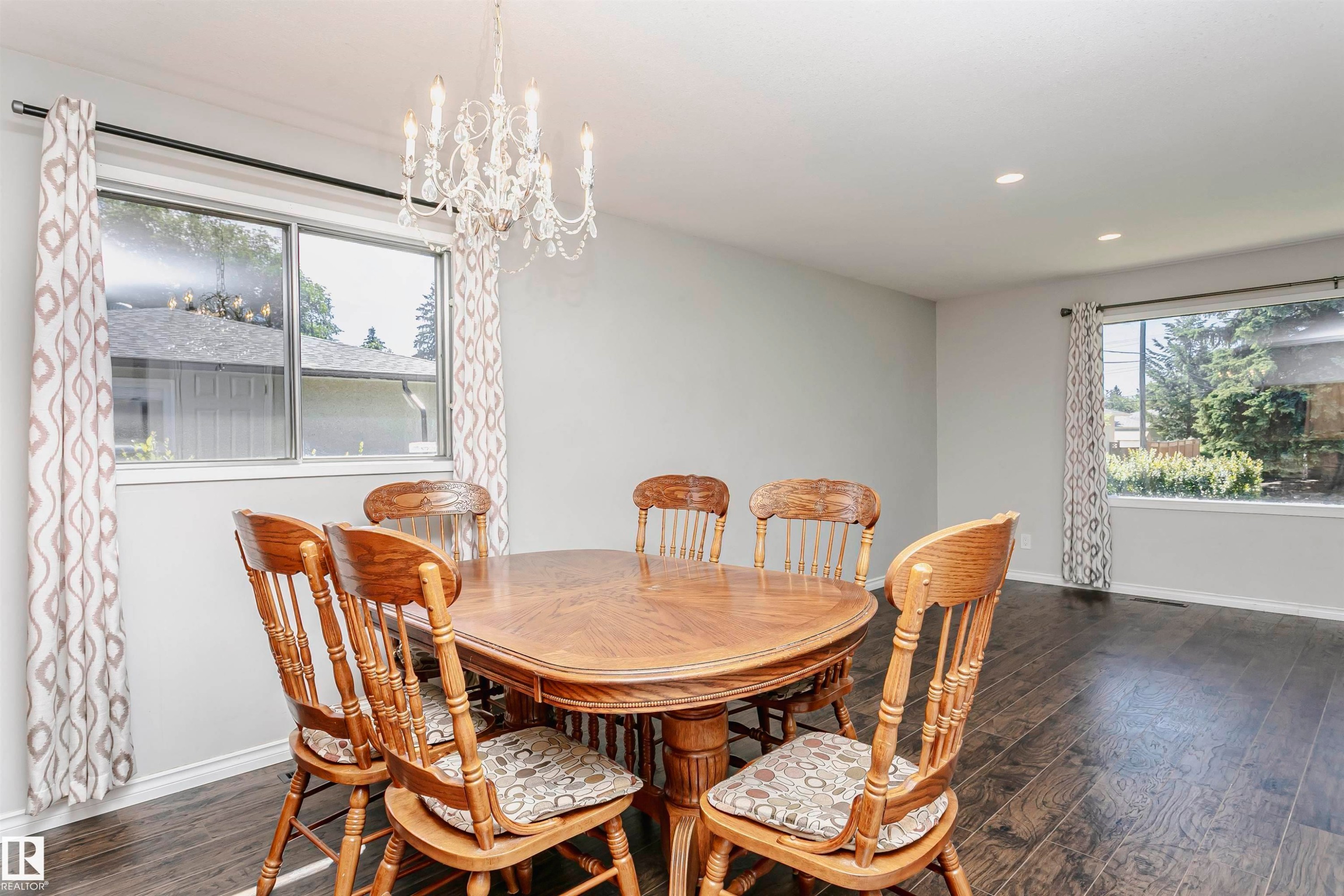 White chandelier, recessed lighting, wood-finish flooring, and white trim - 11440 44A Avenue Nw, Edmonton, AB
