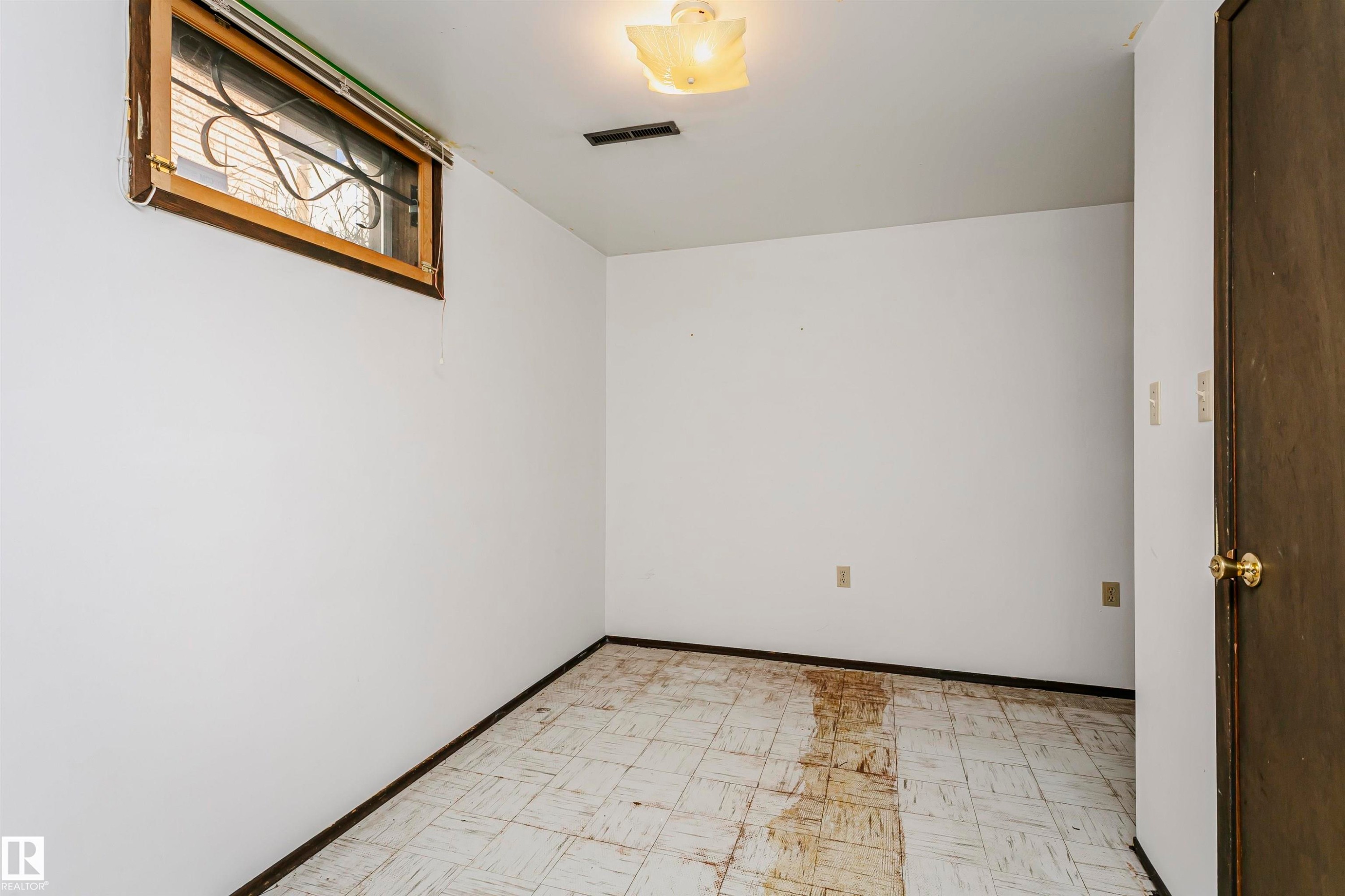 Window with security bars and wood frame - 11440 44A Avenue Nw, Edmonton, AB