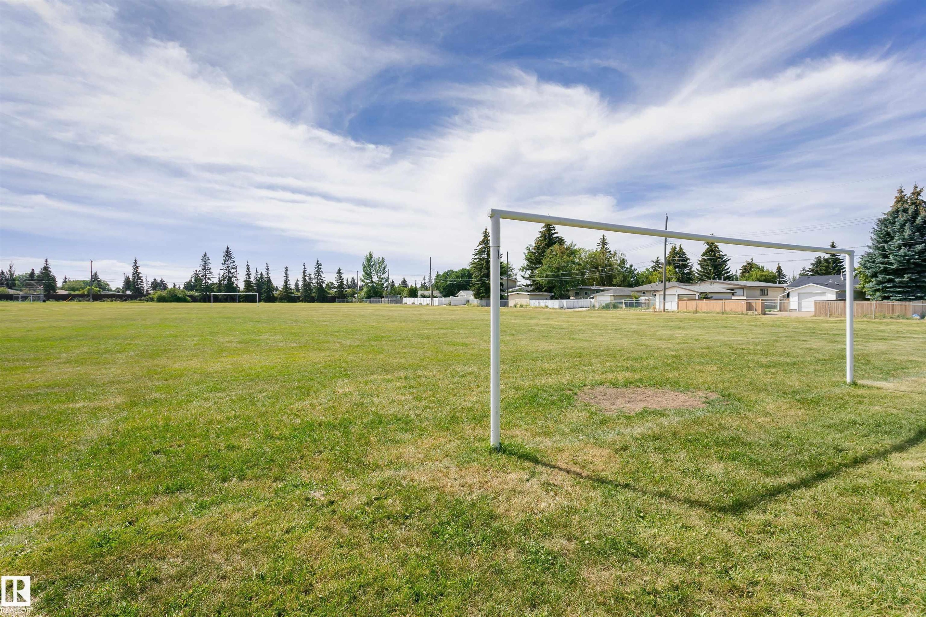 Expansive green space featuring a goalpost and surrounding mature trees - 11440 44A Avenue Nw, Edmonton, AB