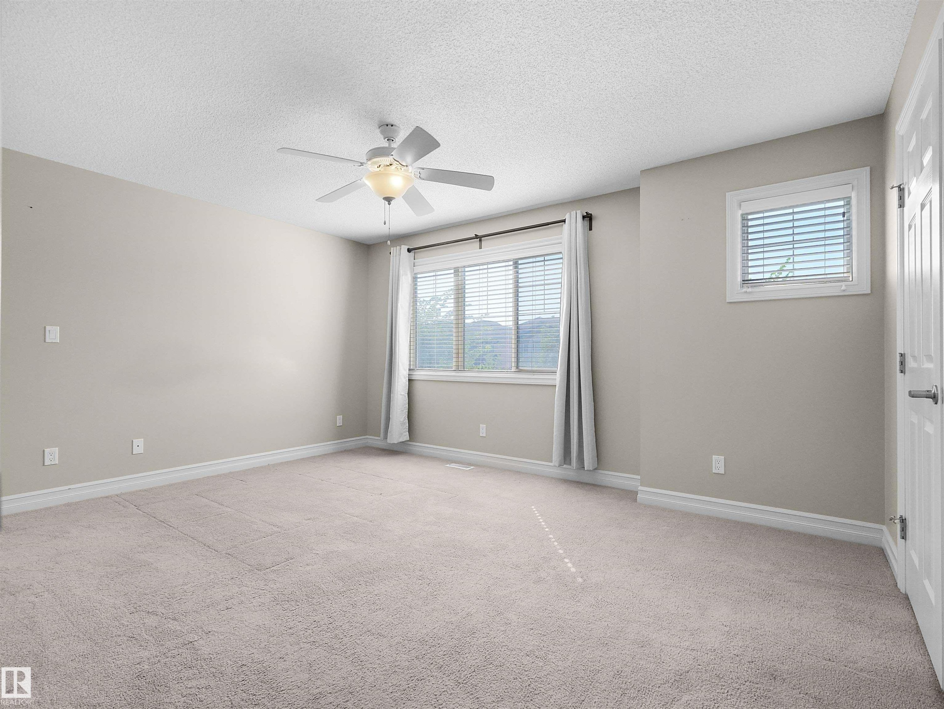 Carpeted flooring, ceiling fan with integrated lighting, window with blinds, additional window with blinds, baseboard trim - 5190 1B Avenue Sw, Edmonton, AB
