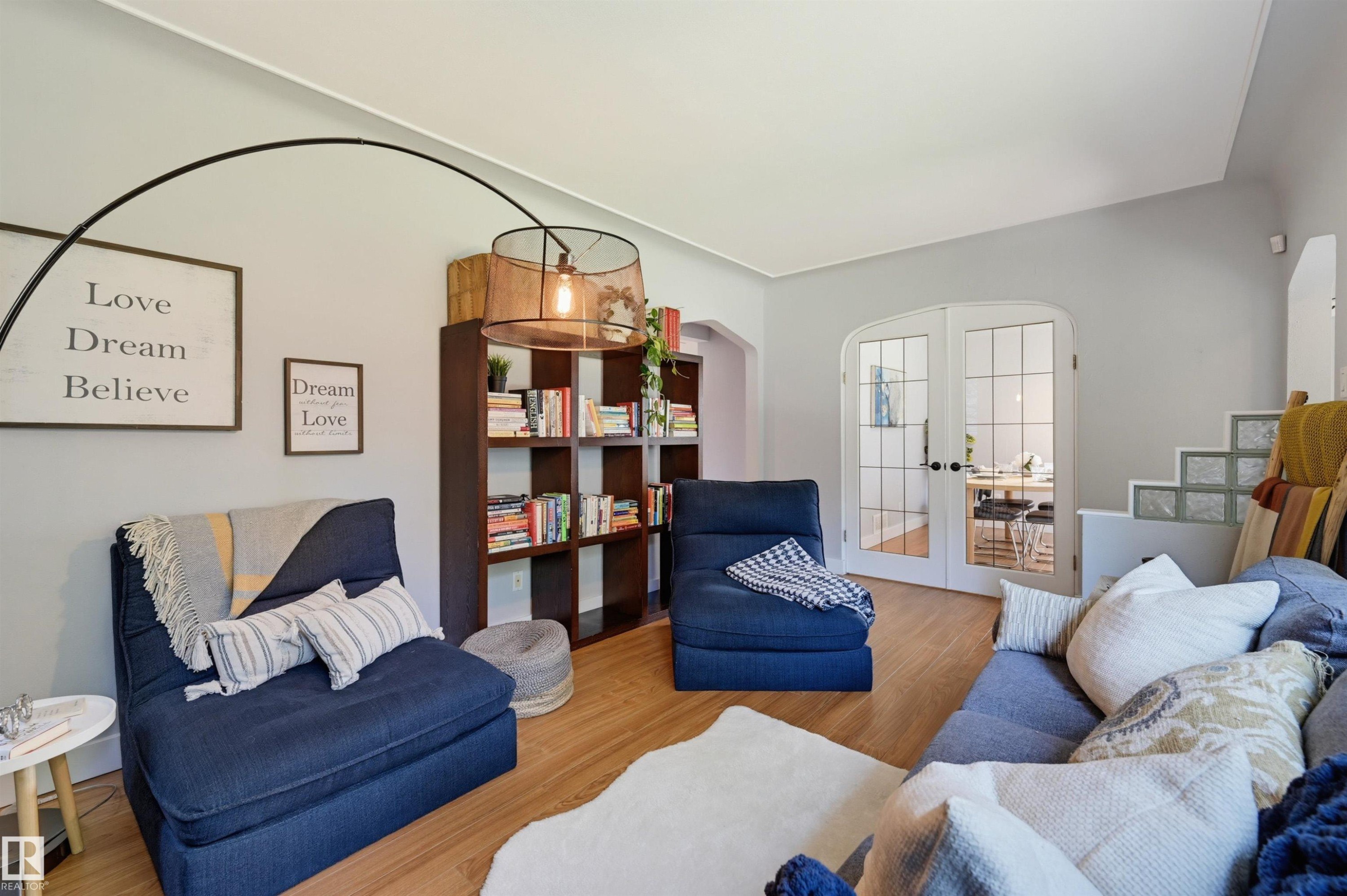 Wood-finish flooring, built-in shelving, glass block architectural details, and arched French doors - 10726 128 Street Nw, Edmonton, AB