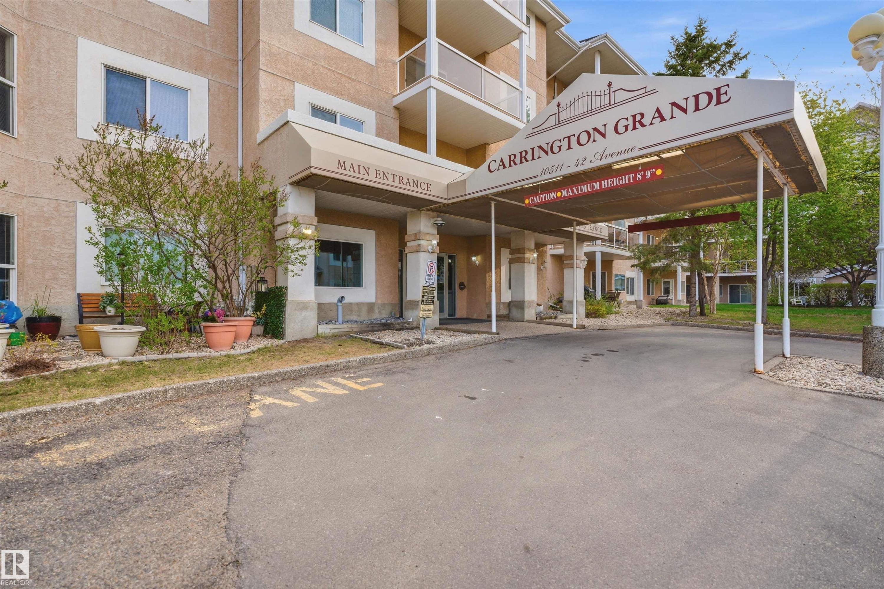 Covered main entrance with stone-clad columns and an exterior awning - #124 10511 42 Av Nw, Edmonton, AB