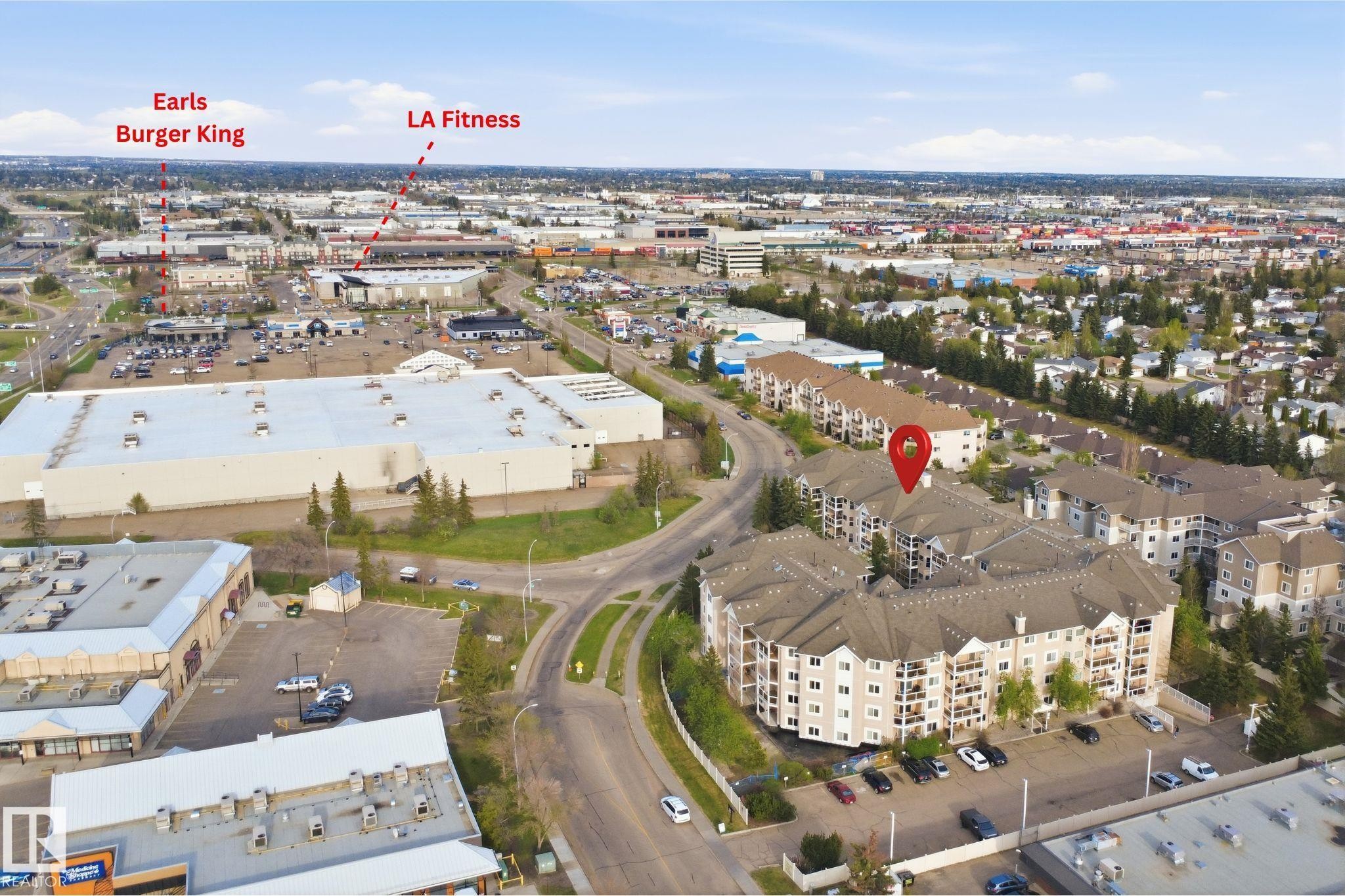 Multi-story residential building with private balconies and surface parking - #124 10511 42 Av Nw, Edmonton, AB
