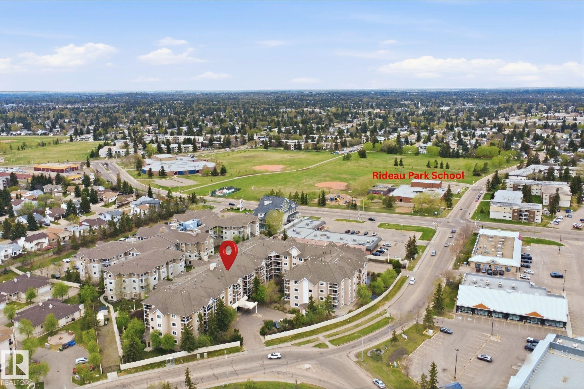 Multi-story residential complex with ample surface parking - #124 10511 42 Av Nw, Edmonton, AB