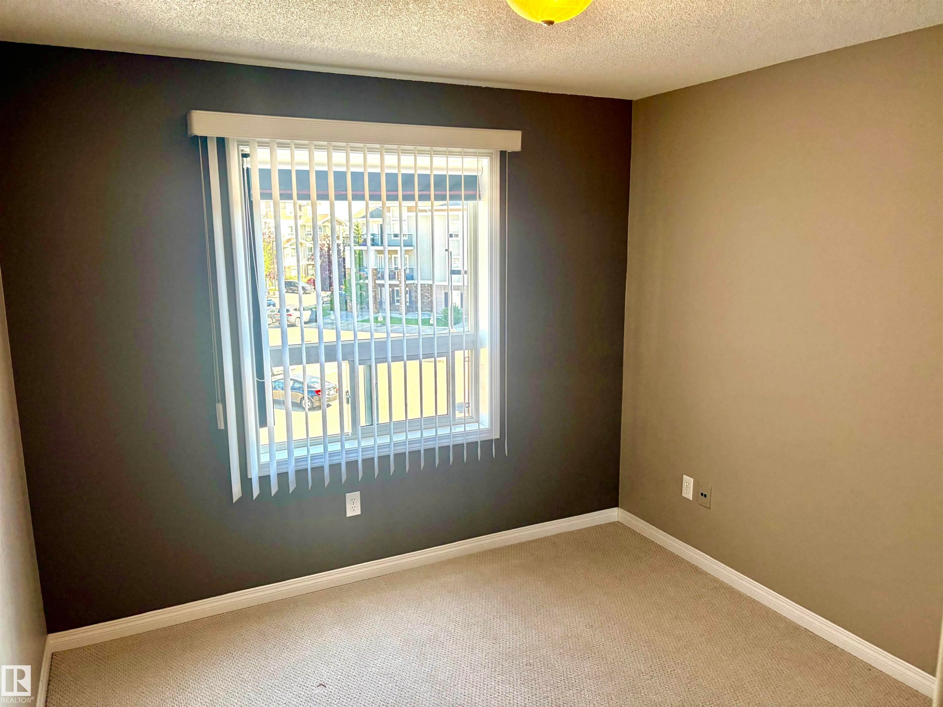 Textured ceiling with a central ceiling light fixture - #1304 9363 Simpson Dr Nw, Edmonton, AB